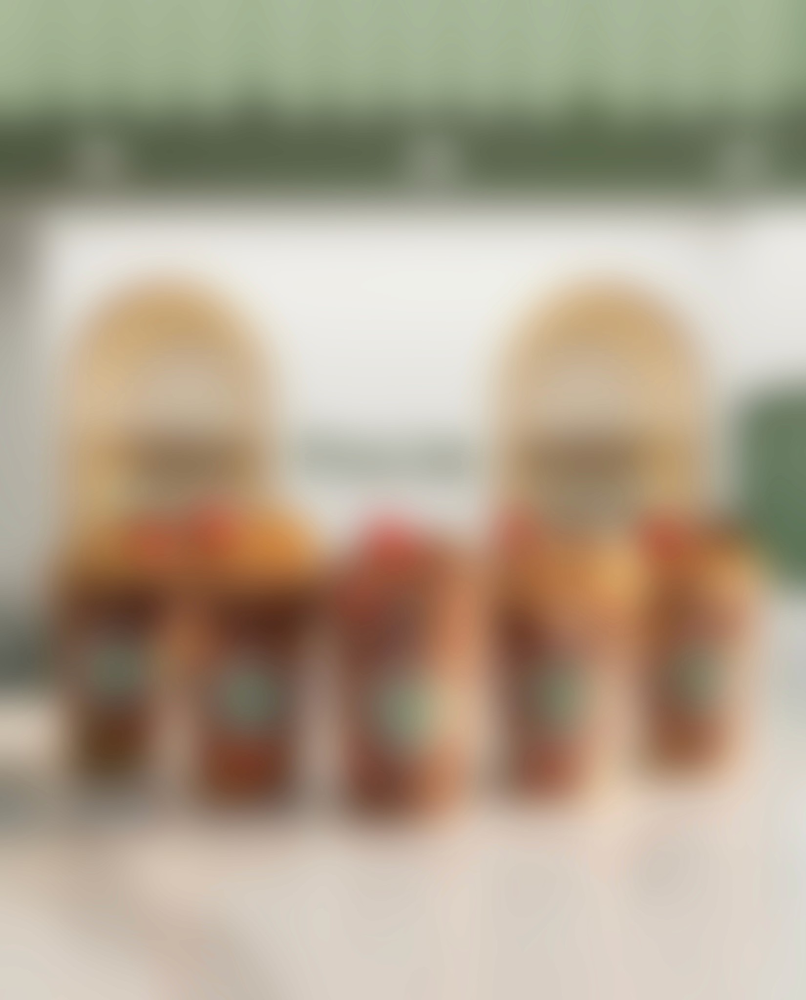 Blurred silhouette of a person standing by a window with red-tinted light and plants