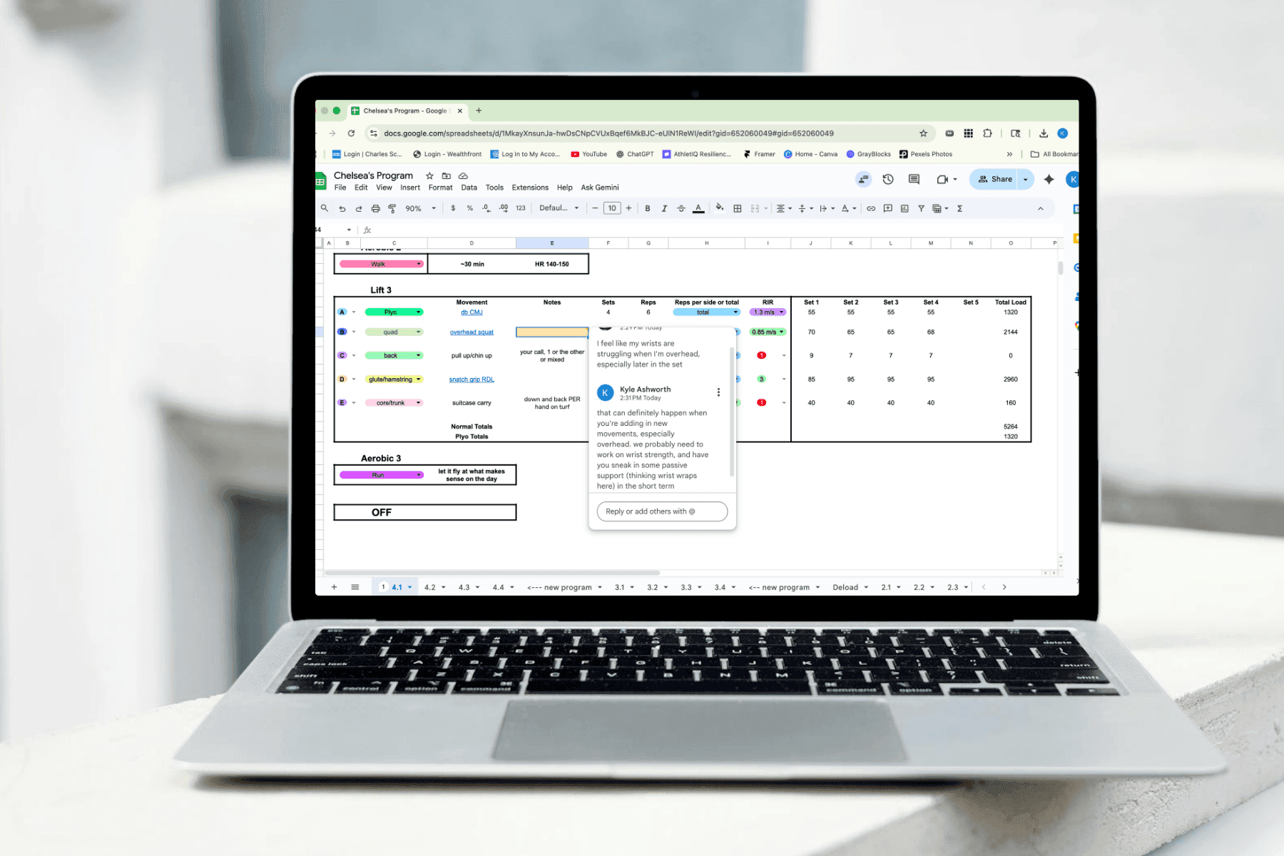 photo of an athlete and coach having a discussion about their training program in the Google sheets app