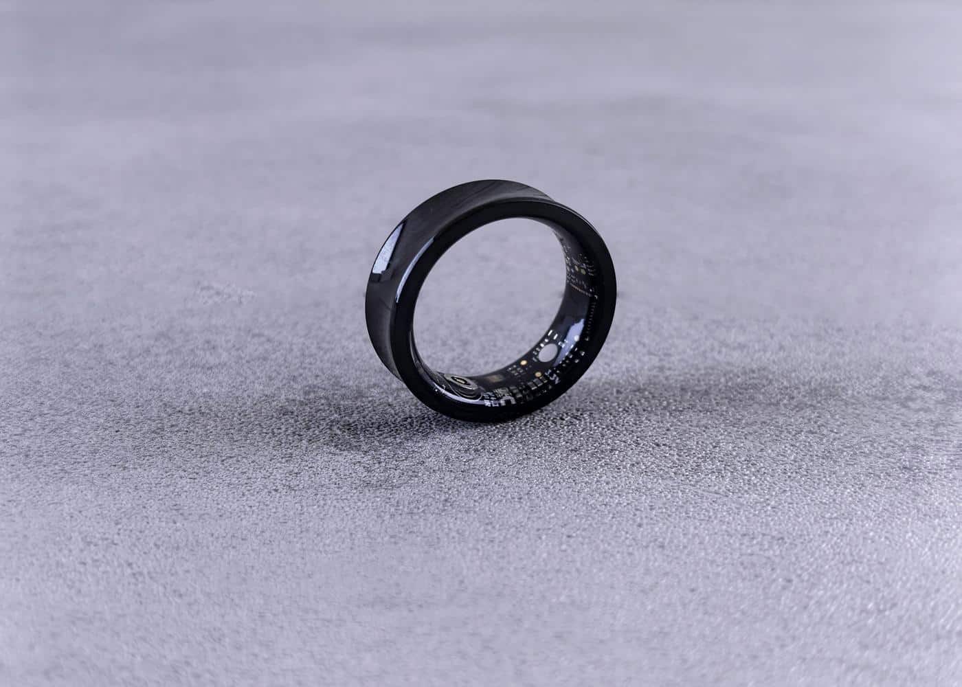 Oura ring gadget standing vertically on flat surface