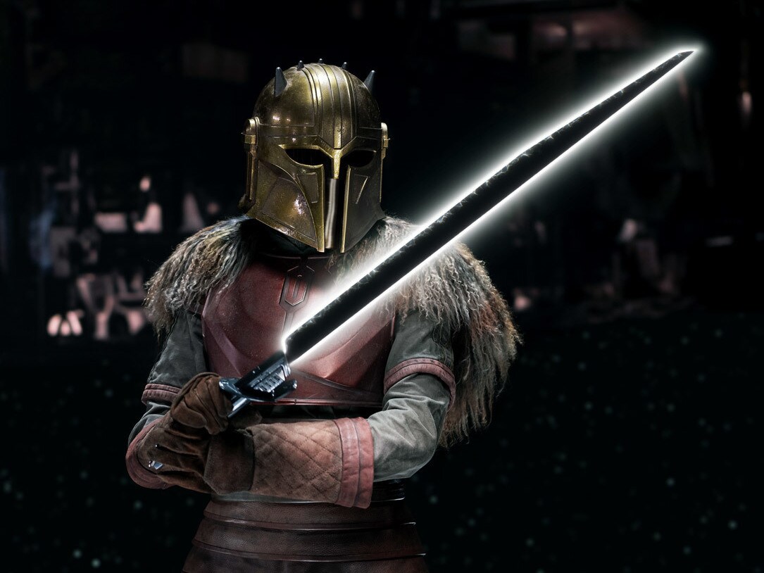 A figure in a golden mask and armor holds a glowing sword, set against a dark, atmospheric background.