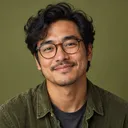 Portrait of Aiko, smiling man with round glasses