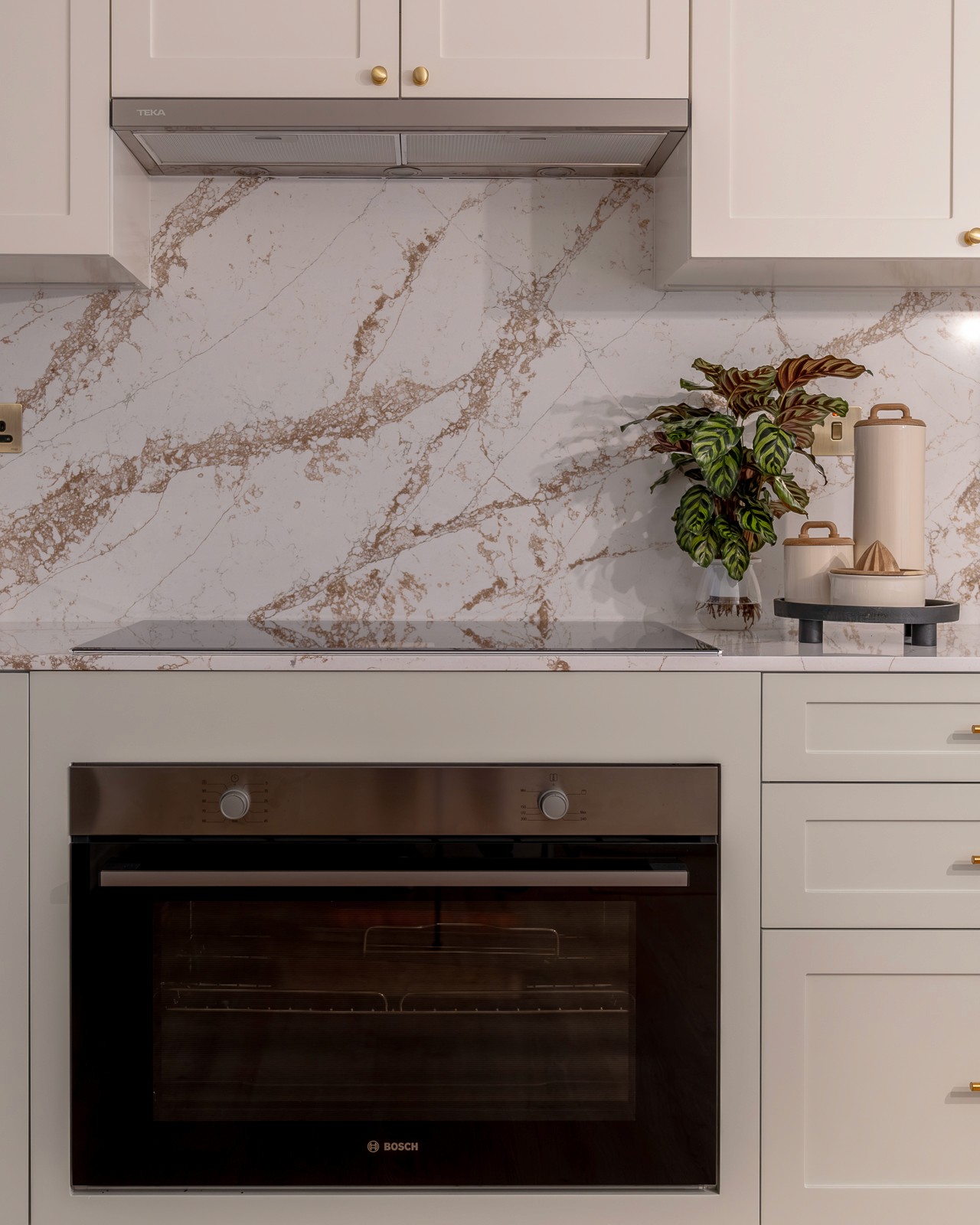 A bright, modern kitchen with marble backsplash