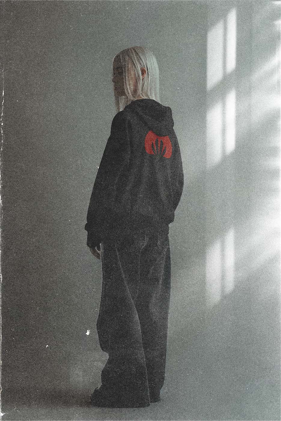 girl model wearing black hoodie with red creep back print.