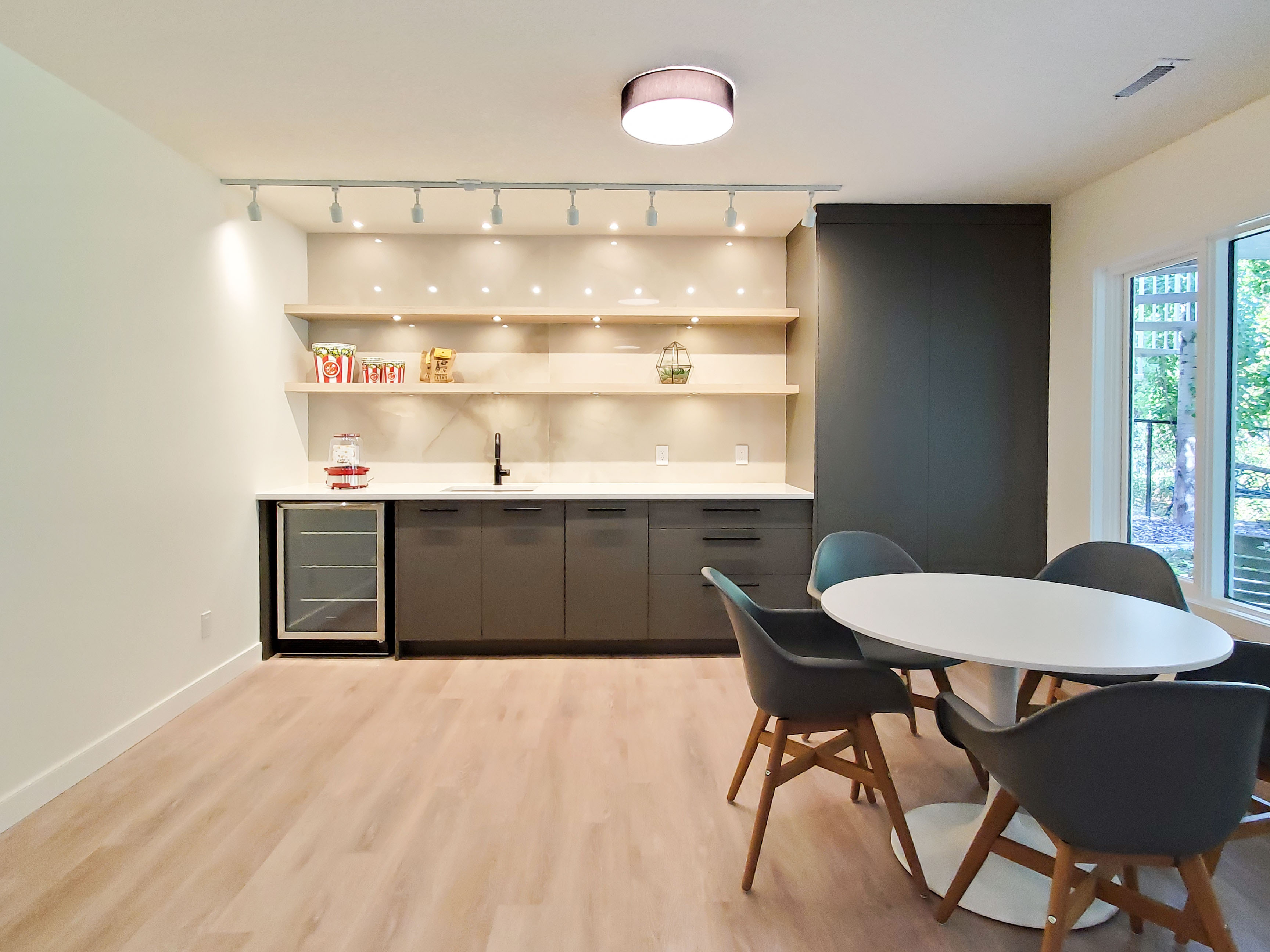 Image of Modern kitchen with sleek countertops, shelving, and built-in wine fridge by KHD Homes design-build team.