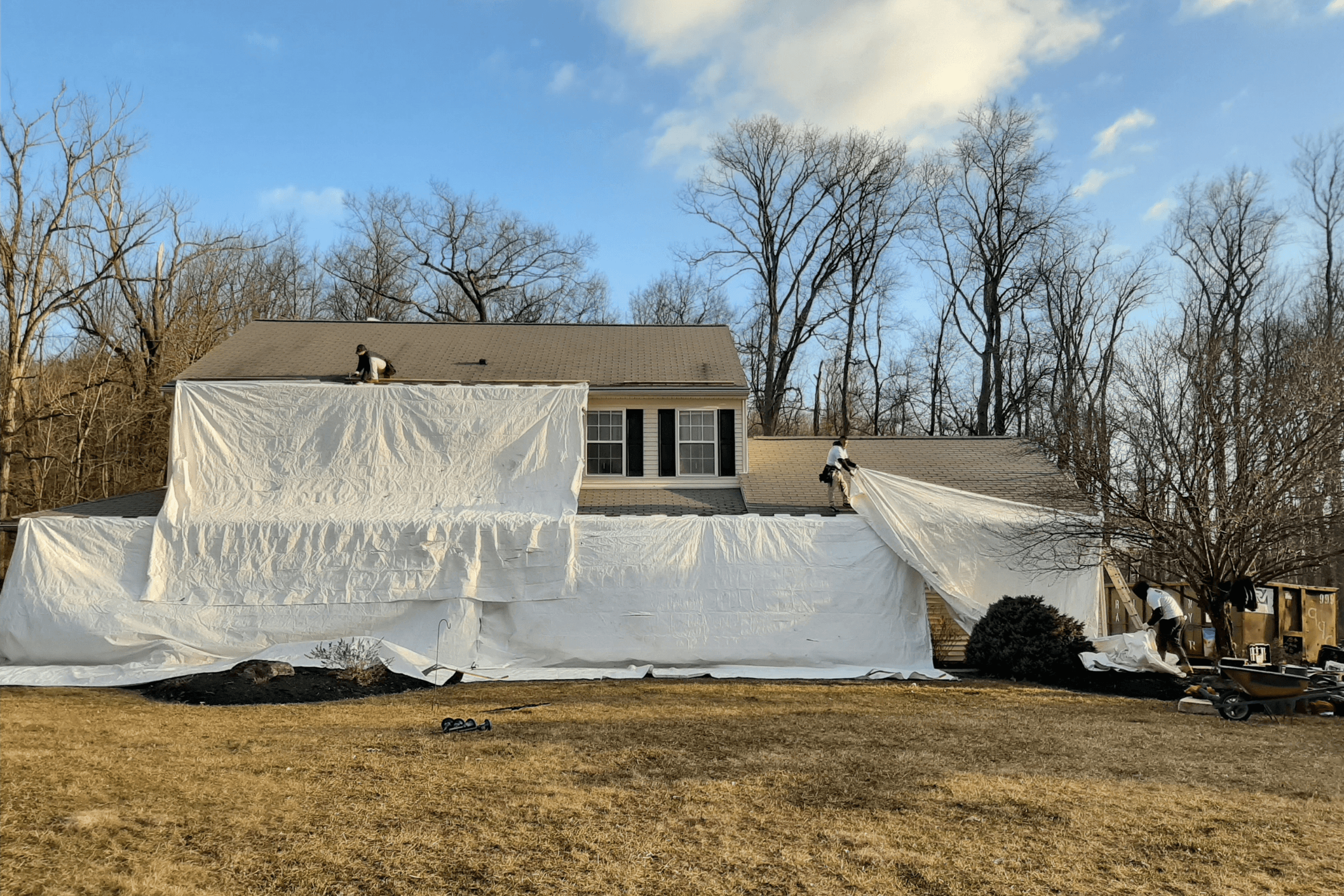 Setting up tarps for roofing tear off on home in Kansas City