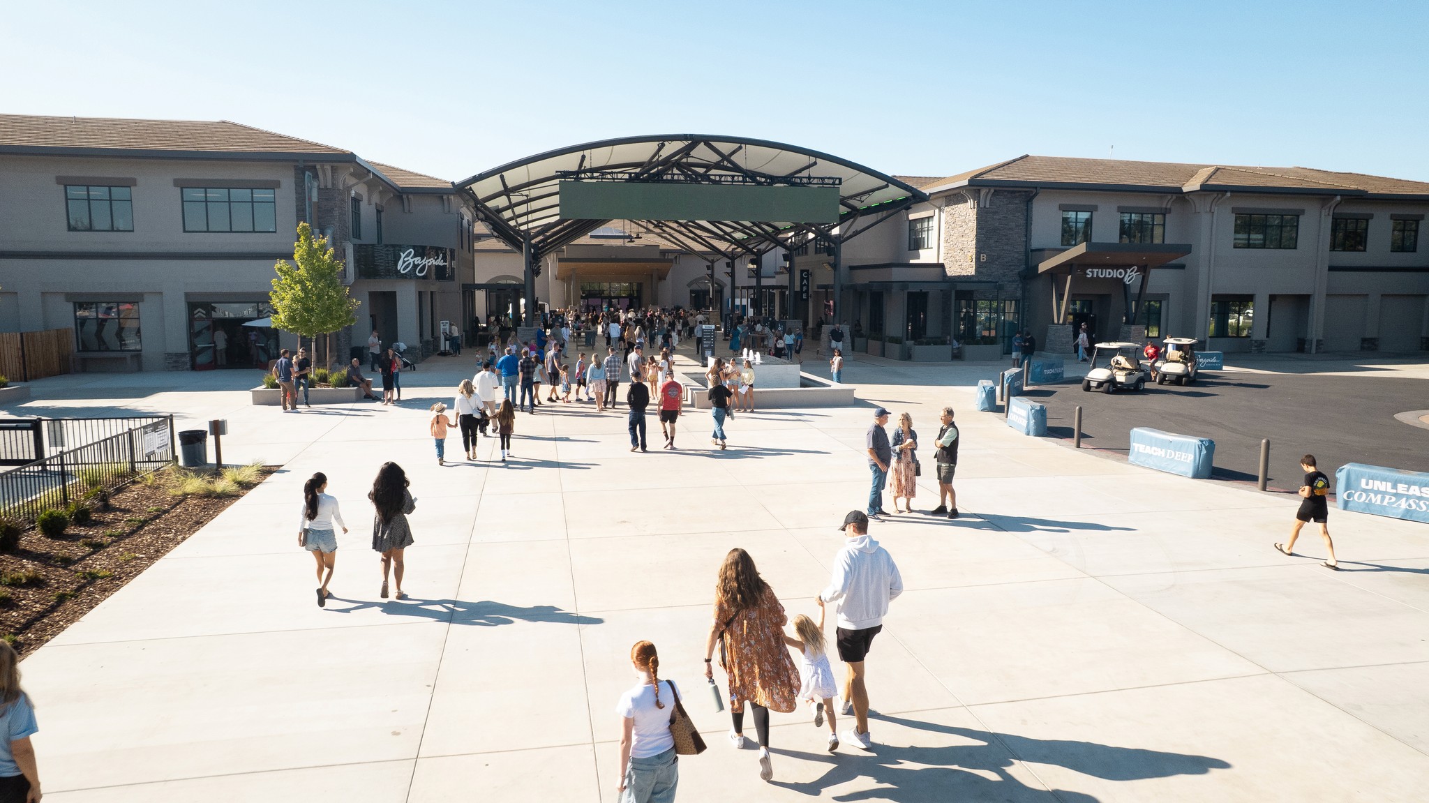 two people in a workspace working on their laptops 