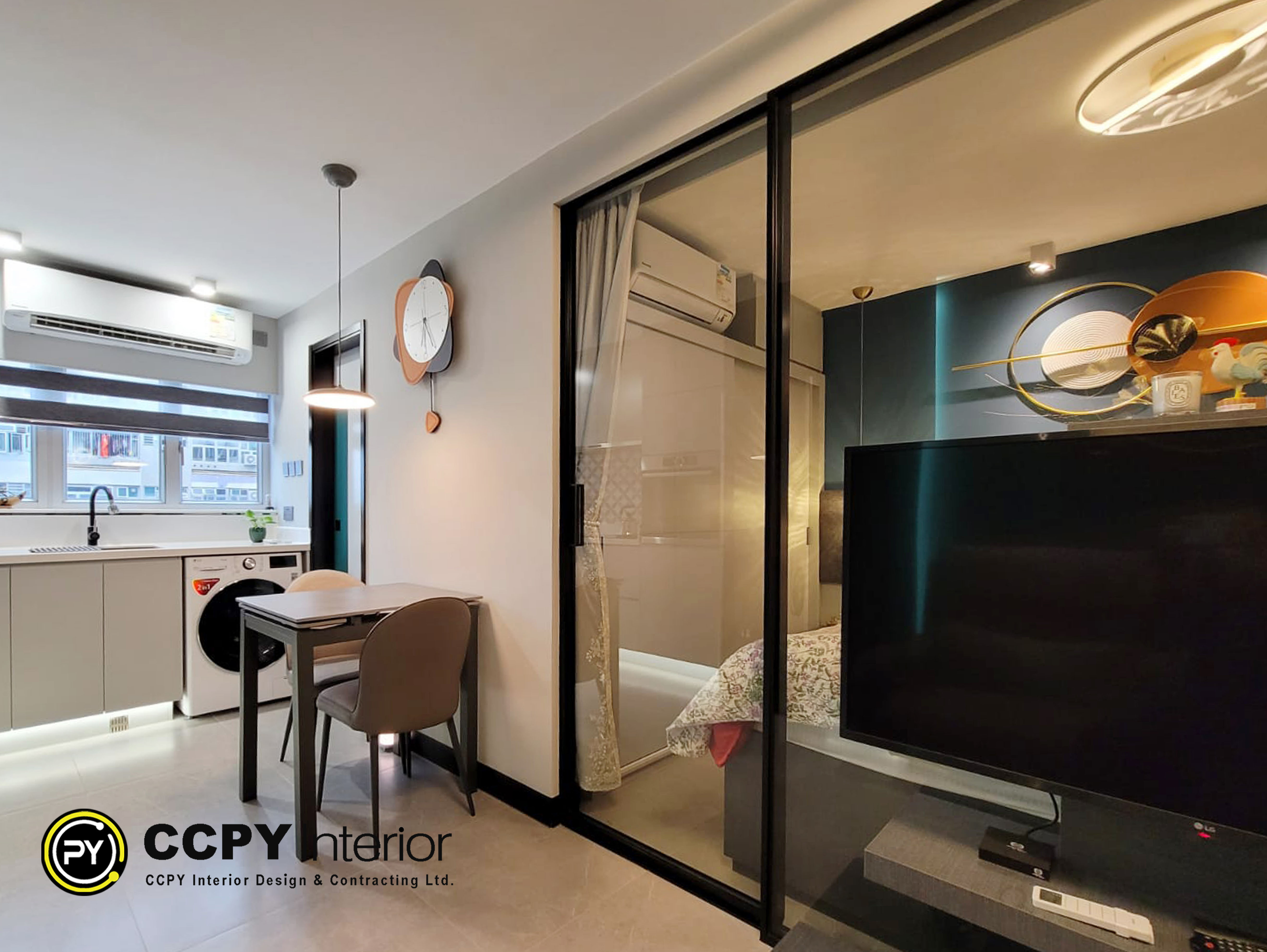 Expansive dining and living zone at Mount Pavilia 20 with floor-to-ceiling windows, a dark oval table, and seamless spatial flow between functional areas.