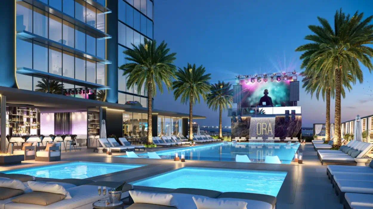 Exterior view of Hotel ORA in downtown Tampa with modern architectural design and skyline backdrop.
