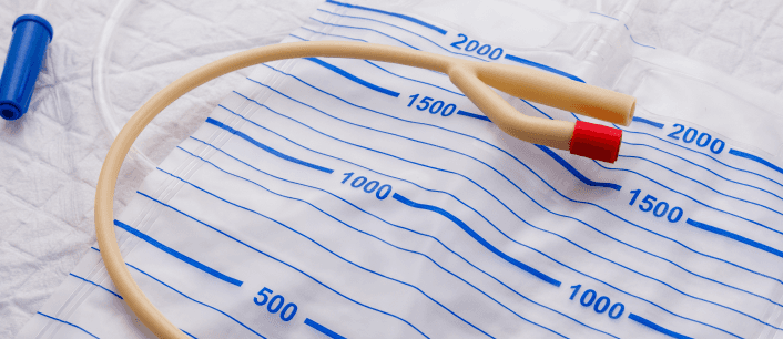 Urinary catheter and drainage bag with measurement markings.