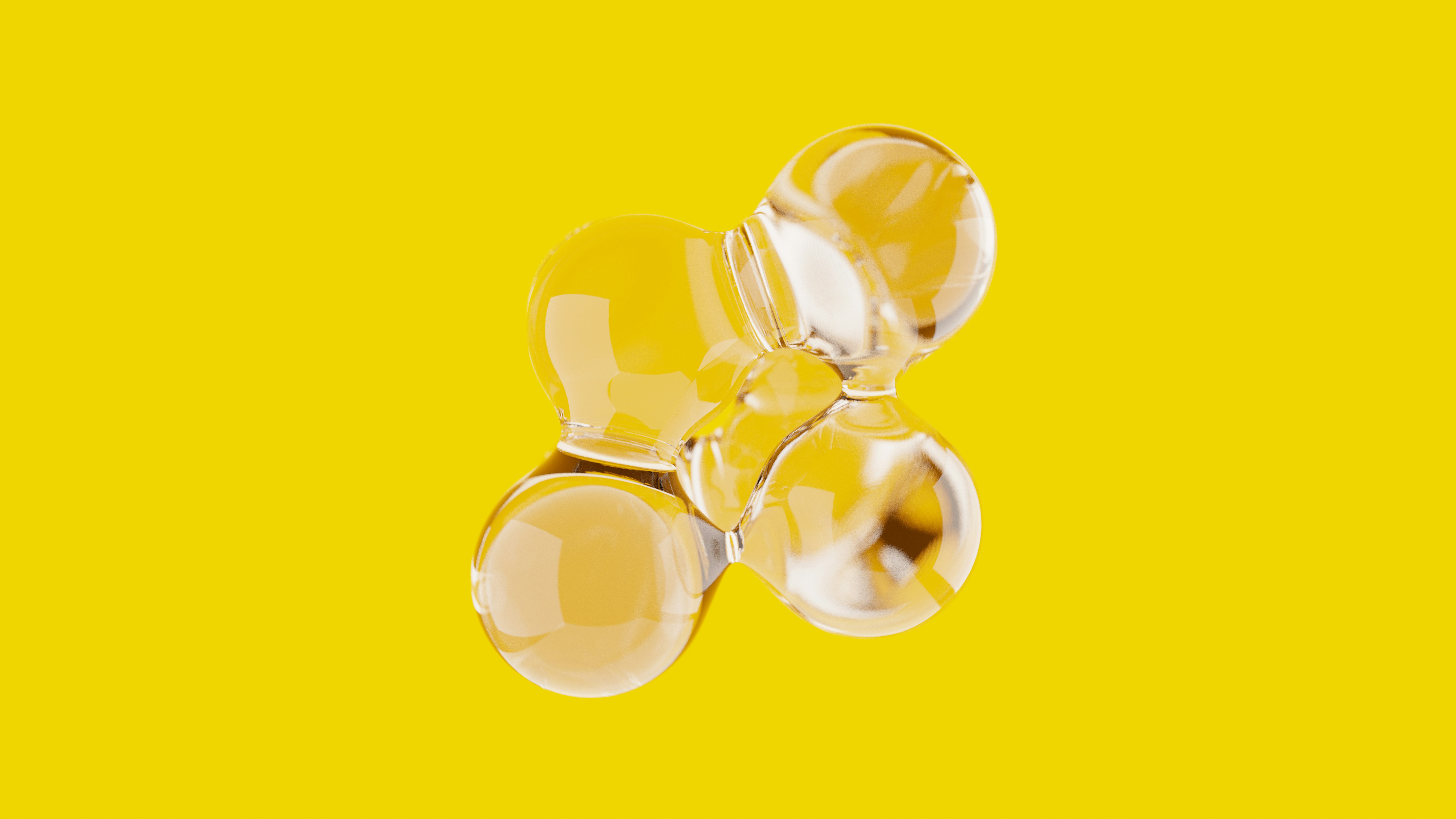 a group of three glass balls on a yellow background