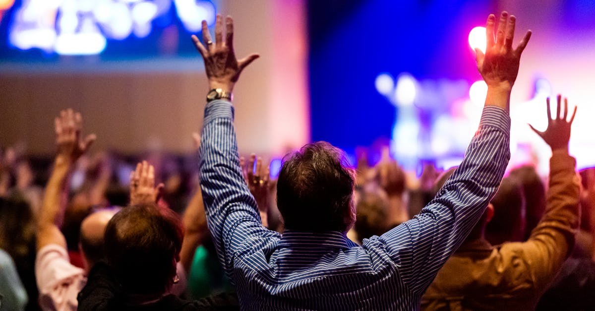 Energizing scene of a crowd enjoying a live music performance with colorful stage lights.