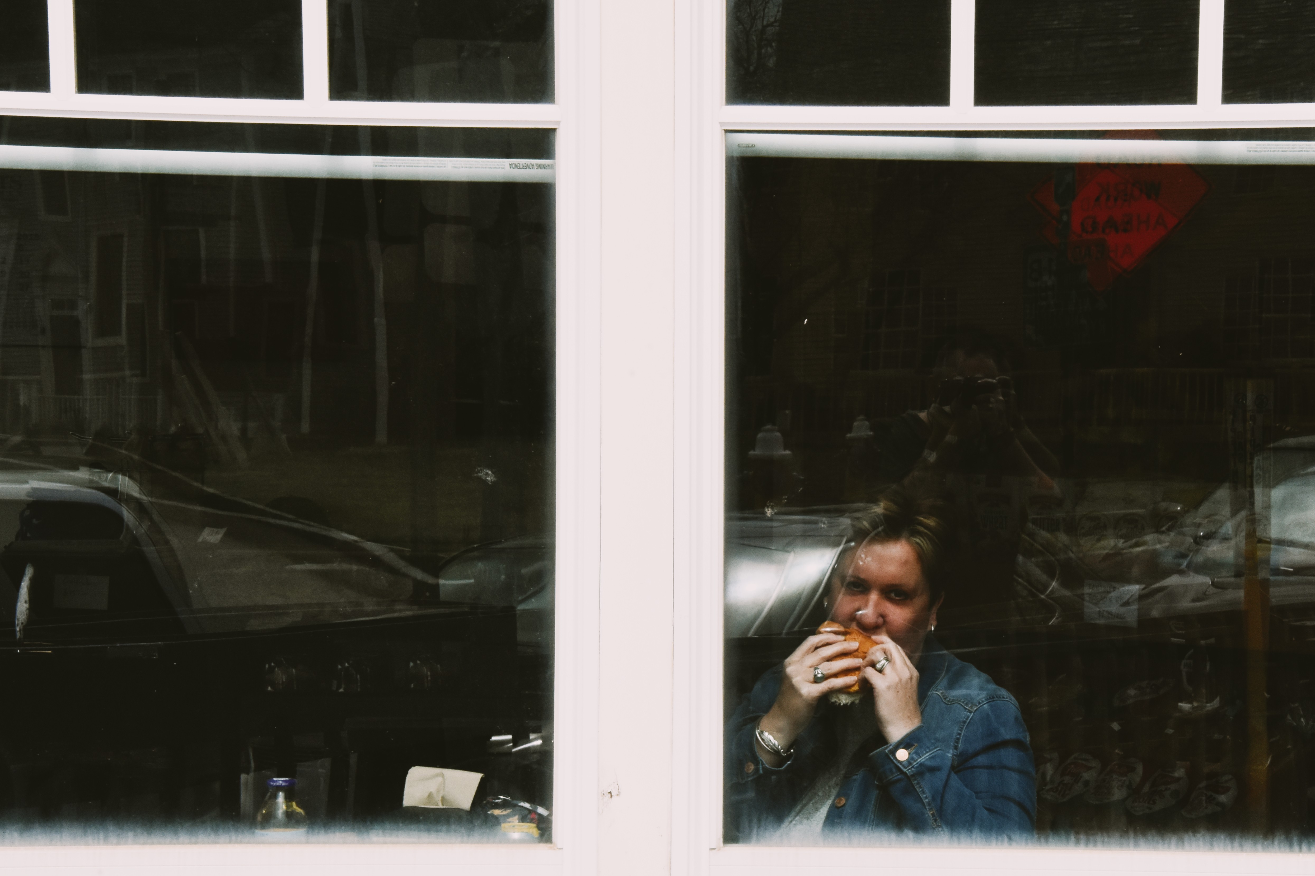 A quiet observational portrait through a window