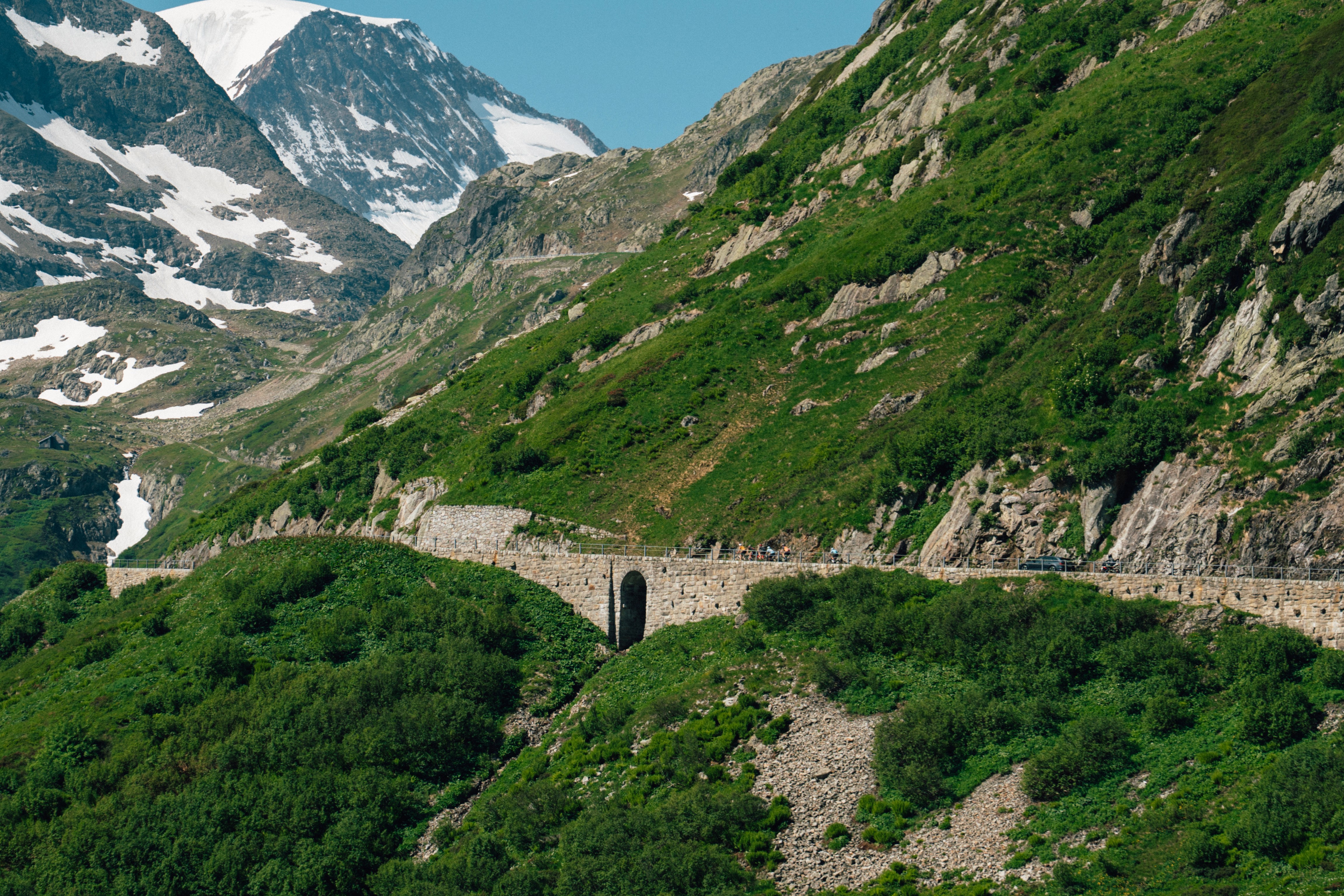 Sweeping view of the Swiss Alps and cyclists