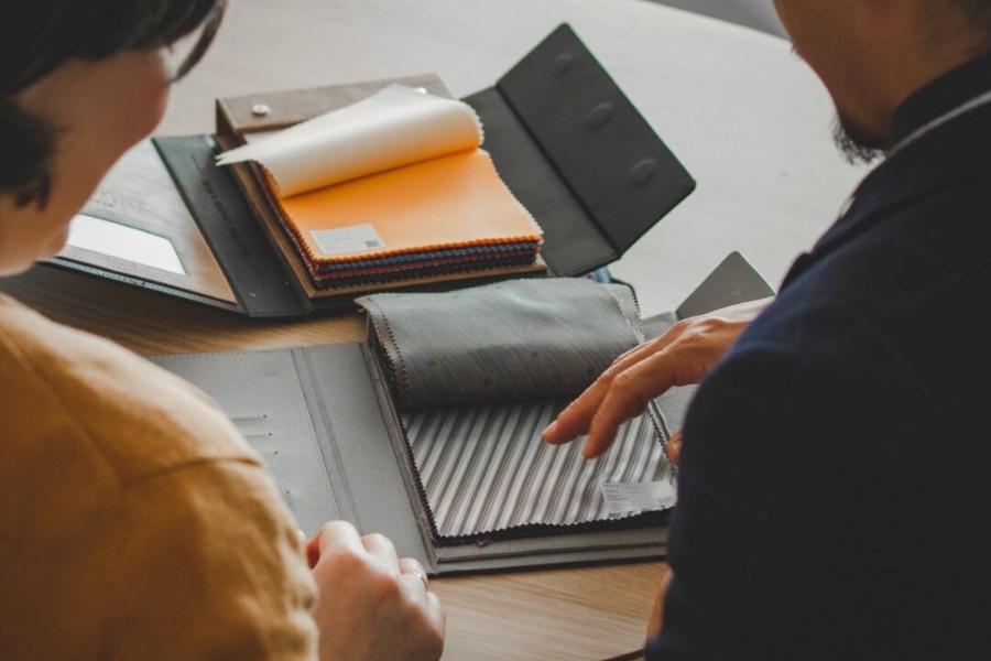 Isadora Nim Image showing Peter choosing high quality fabrics for a bespoke custom suit for his woman client