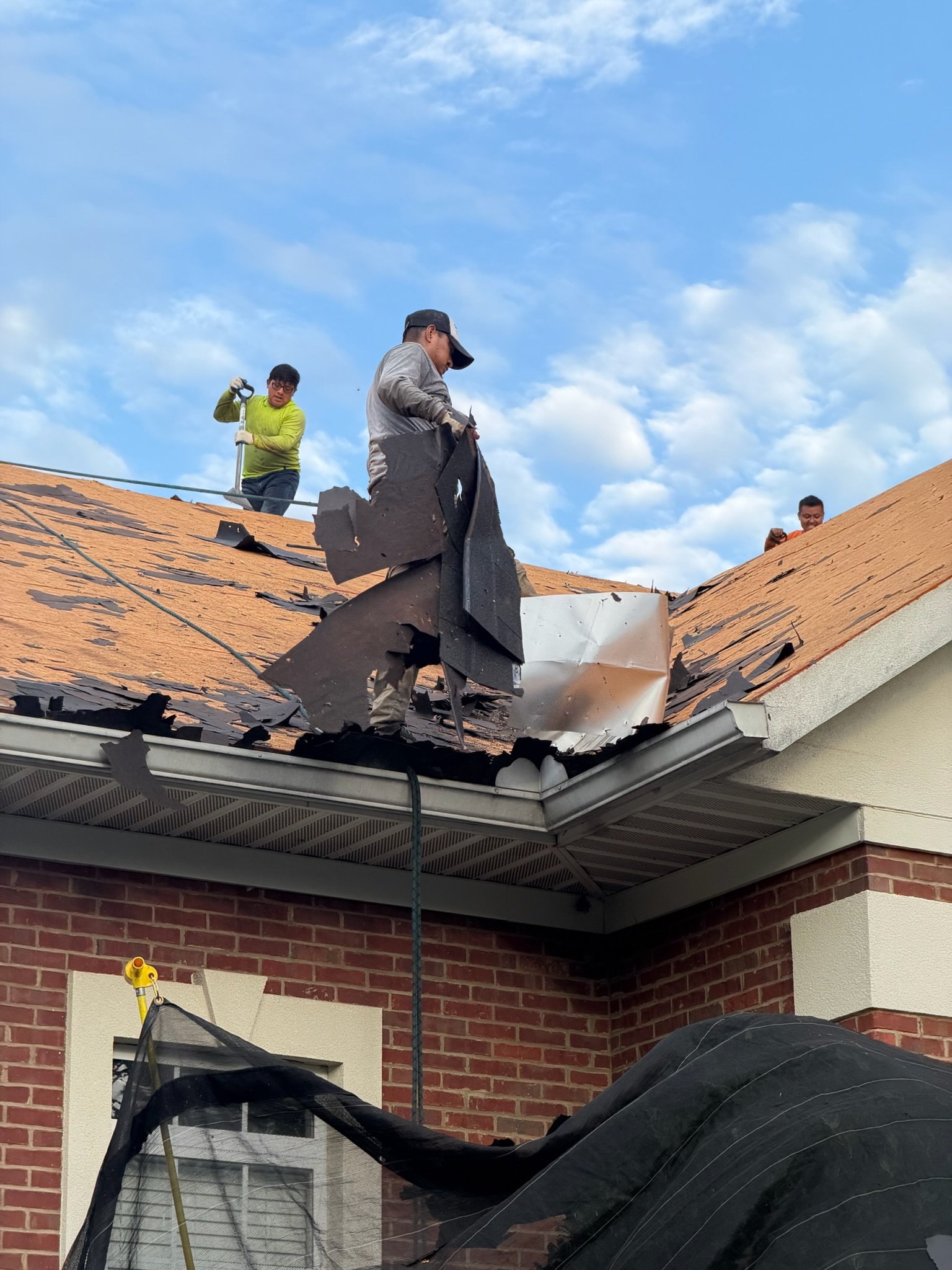 SkyPro crew installing the new roof on a one-story brick office building in Lawrenceville, GA