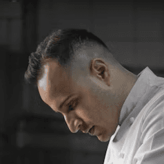 woman in white robe holding chopsticks