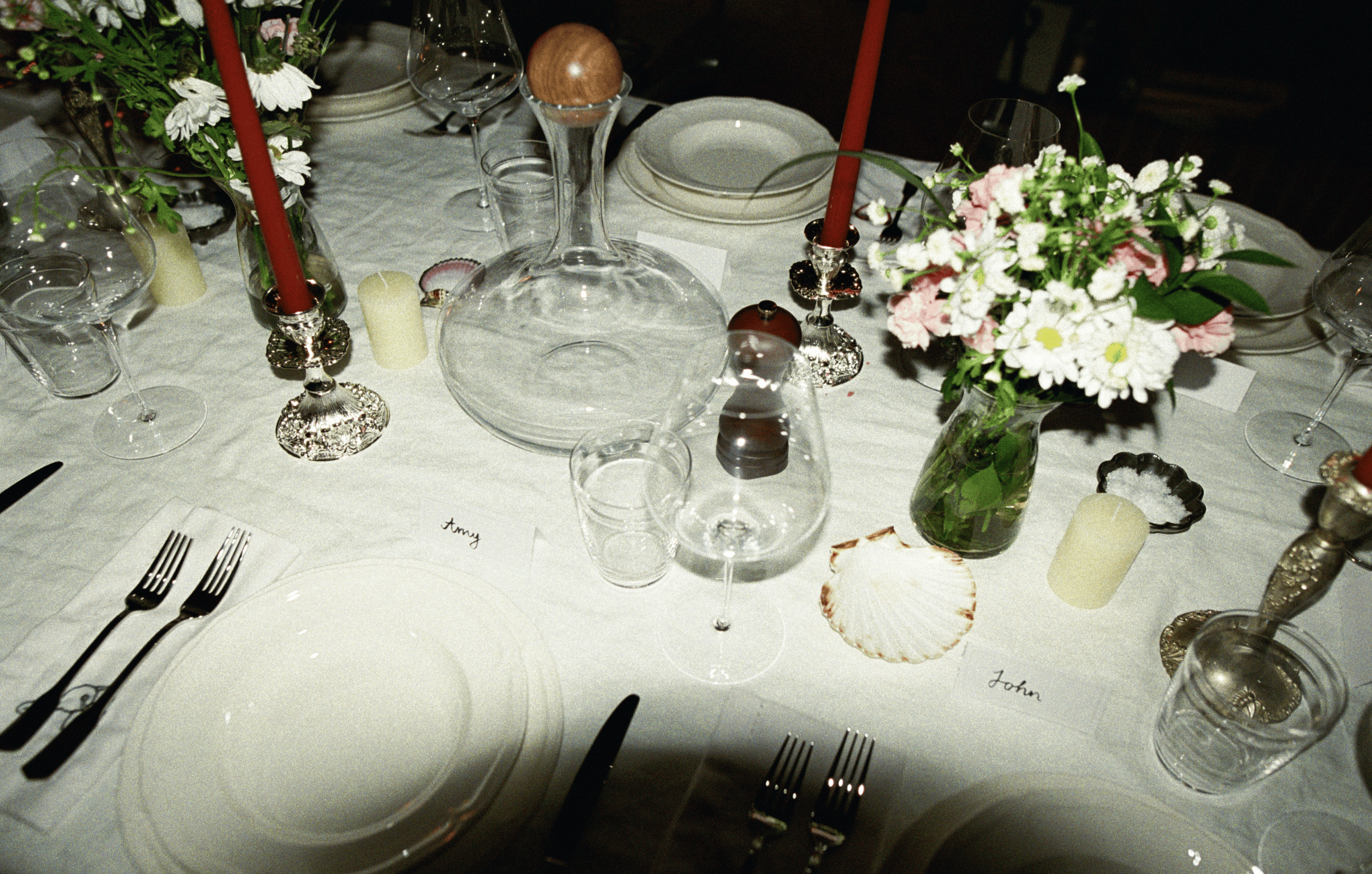 A decorative floral arrangement spills over a table draped in red fabric, creating an elegant atmosphere.