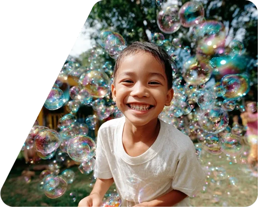 A joyful child smiles broadly, surrounded by iridescent bubbles in a sunlit garden, conveying a sense of happiness and playfulness.