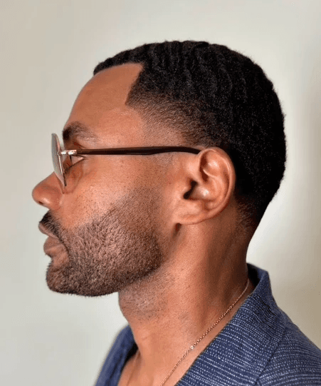 Mid Taper fade with a bold, modern edge tailored for men by expert barber Courtney Palmore.  Hair color and beard grooming with hair color.
