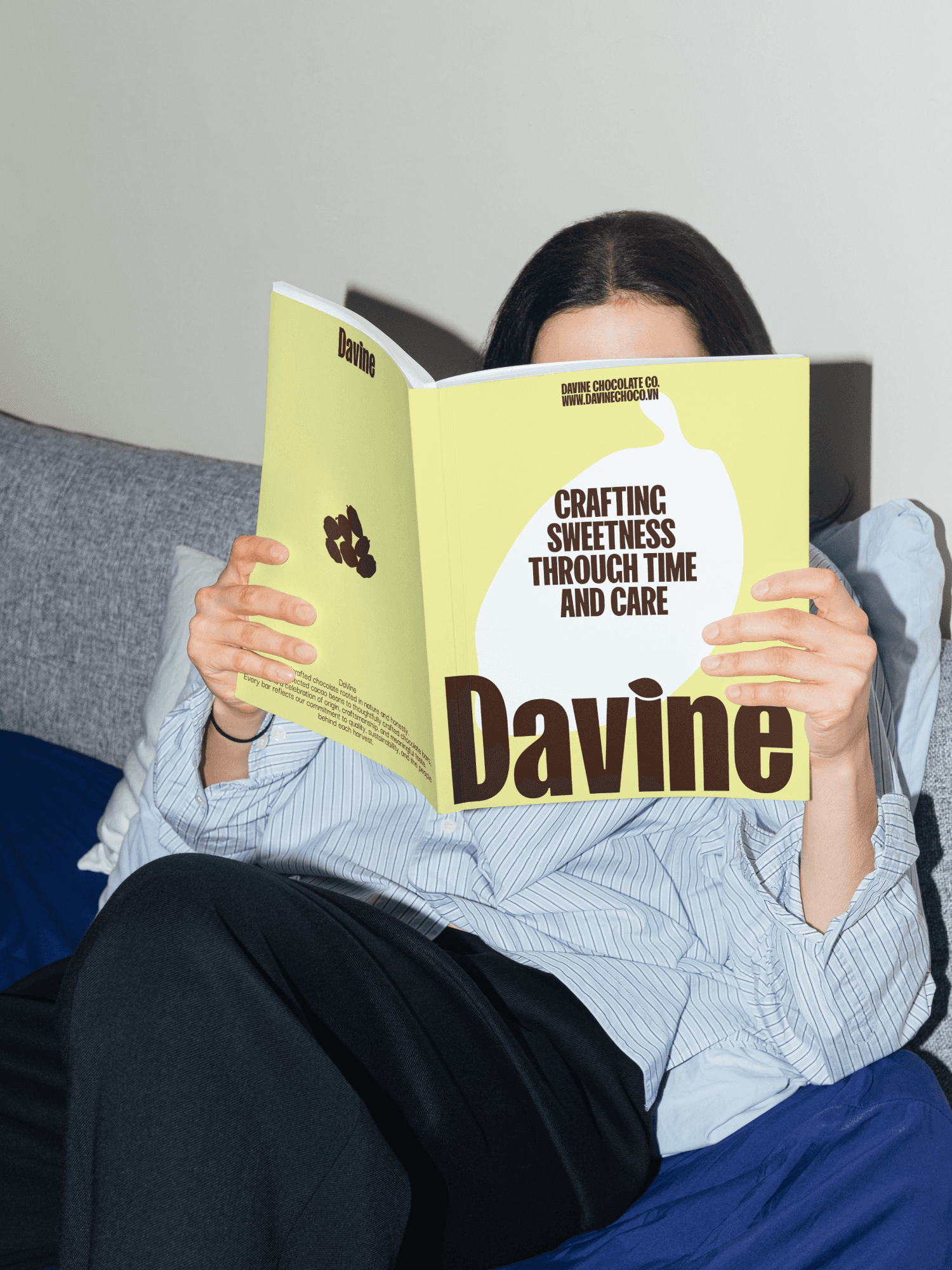A close-up of a hand wearing multiple decorative rings against a blue background.