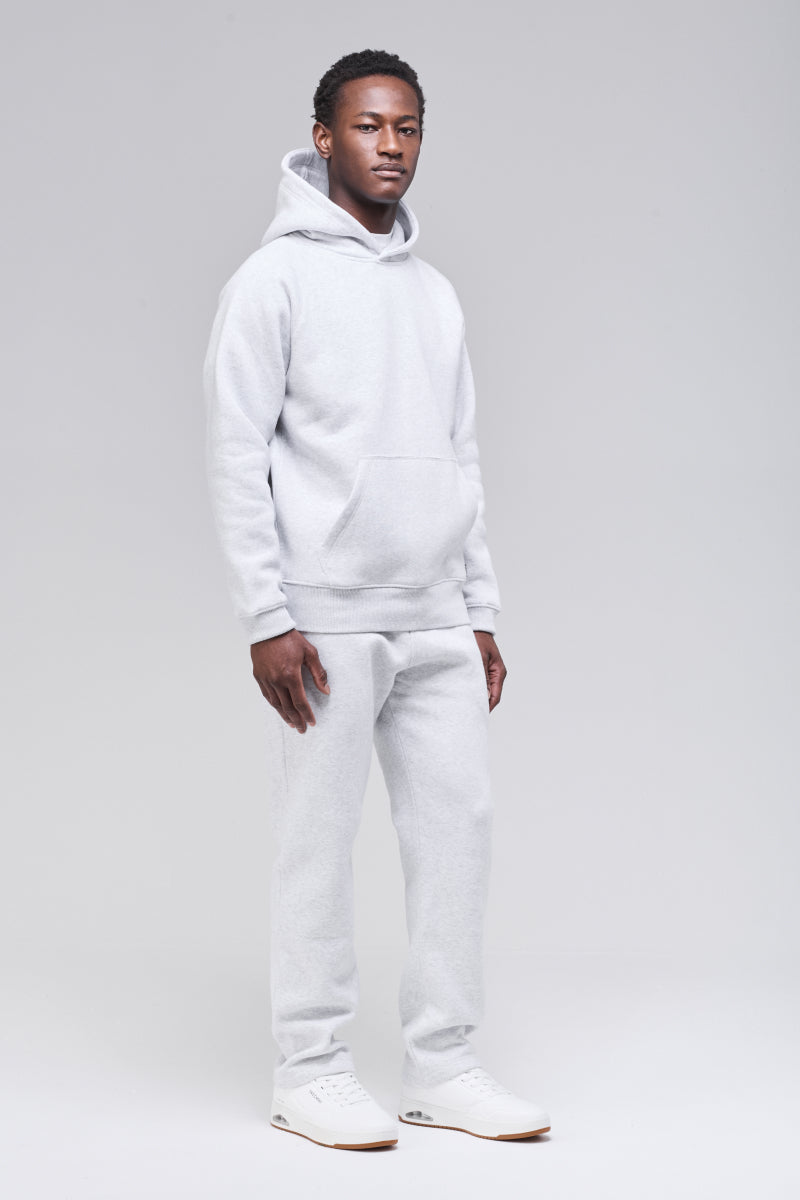 Male model wearing grey classic hoodie, front side view, full figure