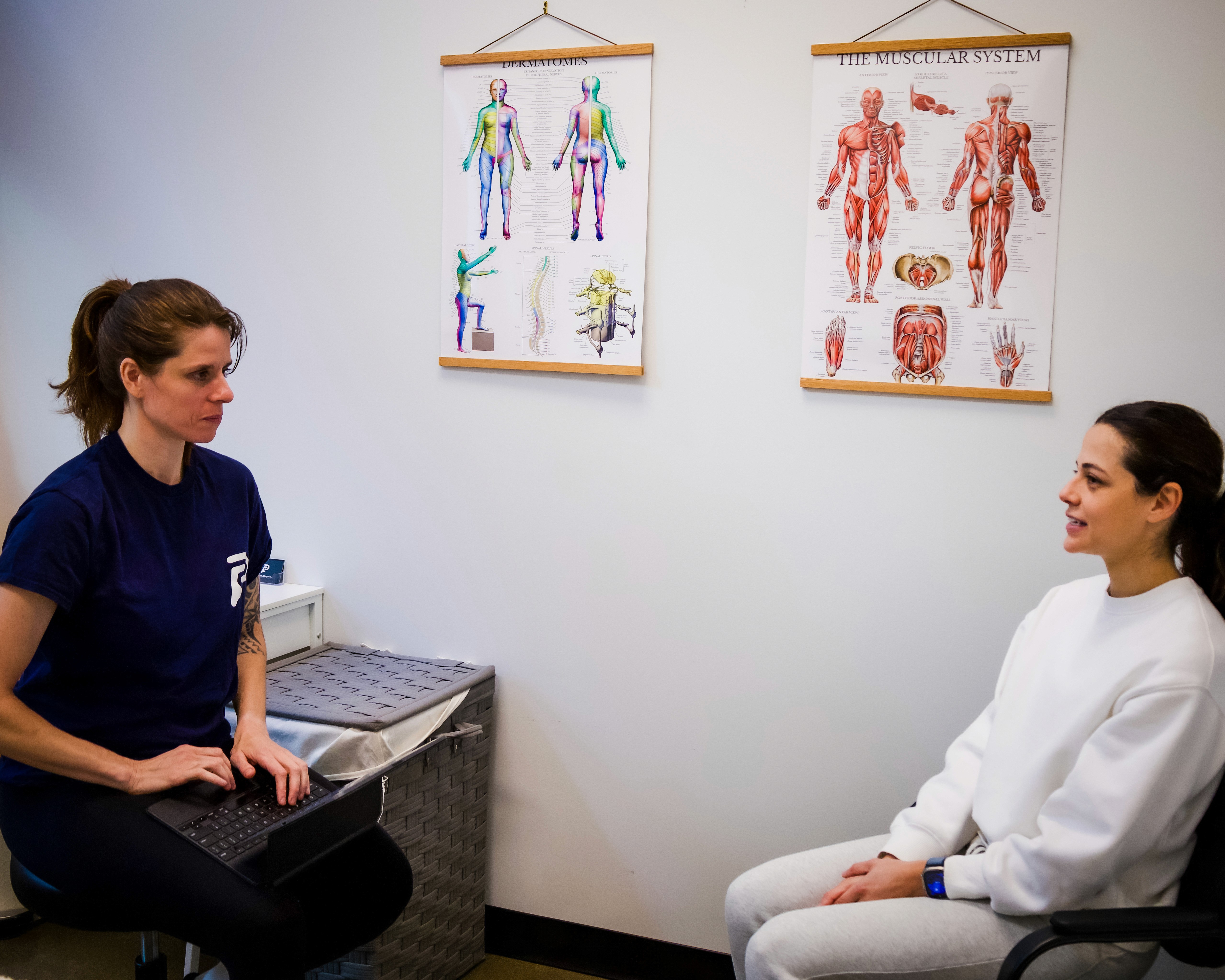 physiotherapist taking patient intake in a treatment room