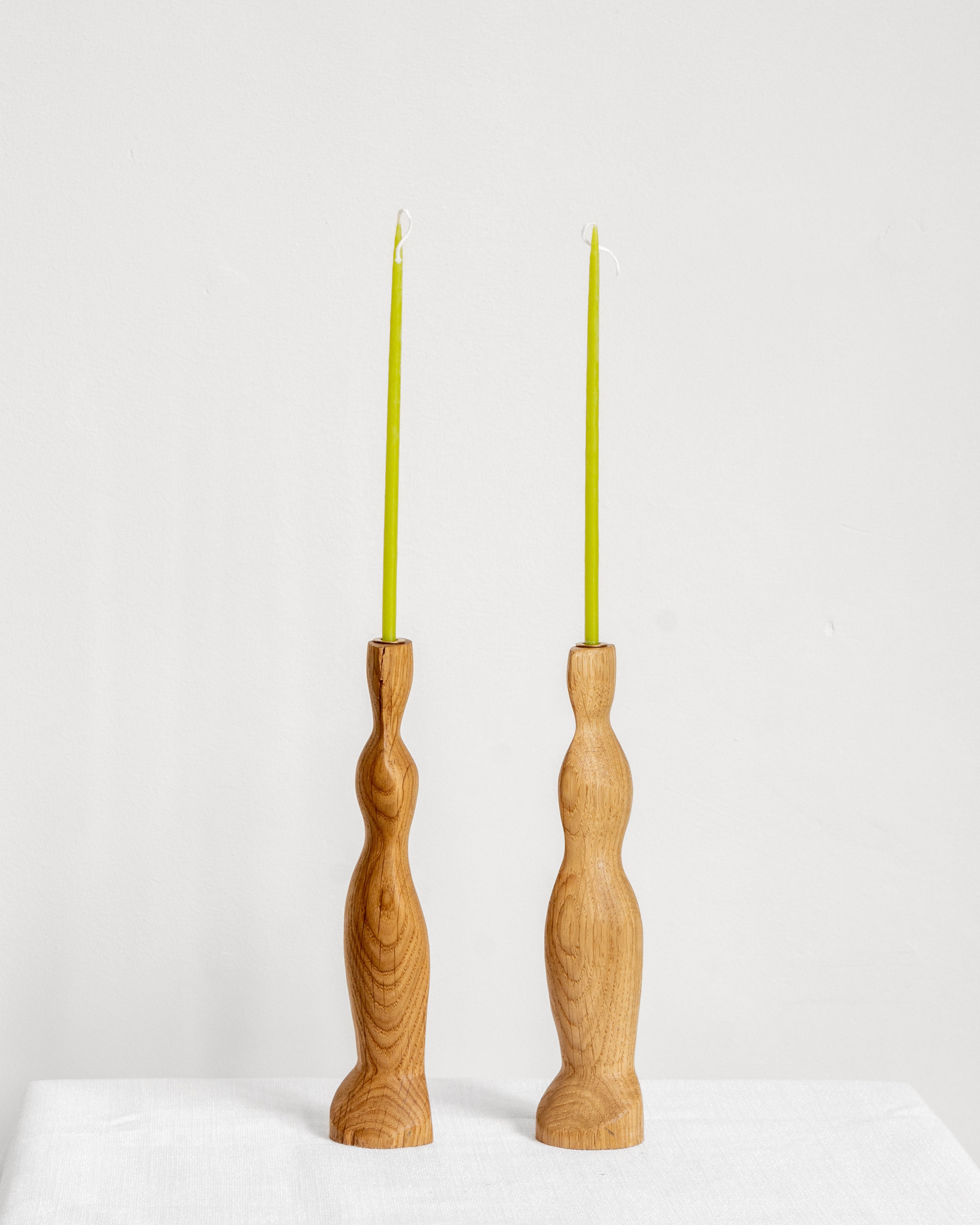 Figura Candlestick holders in Oak on white background with green candles