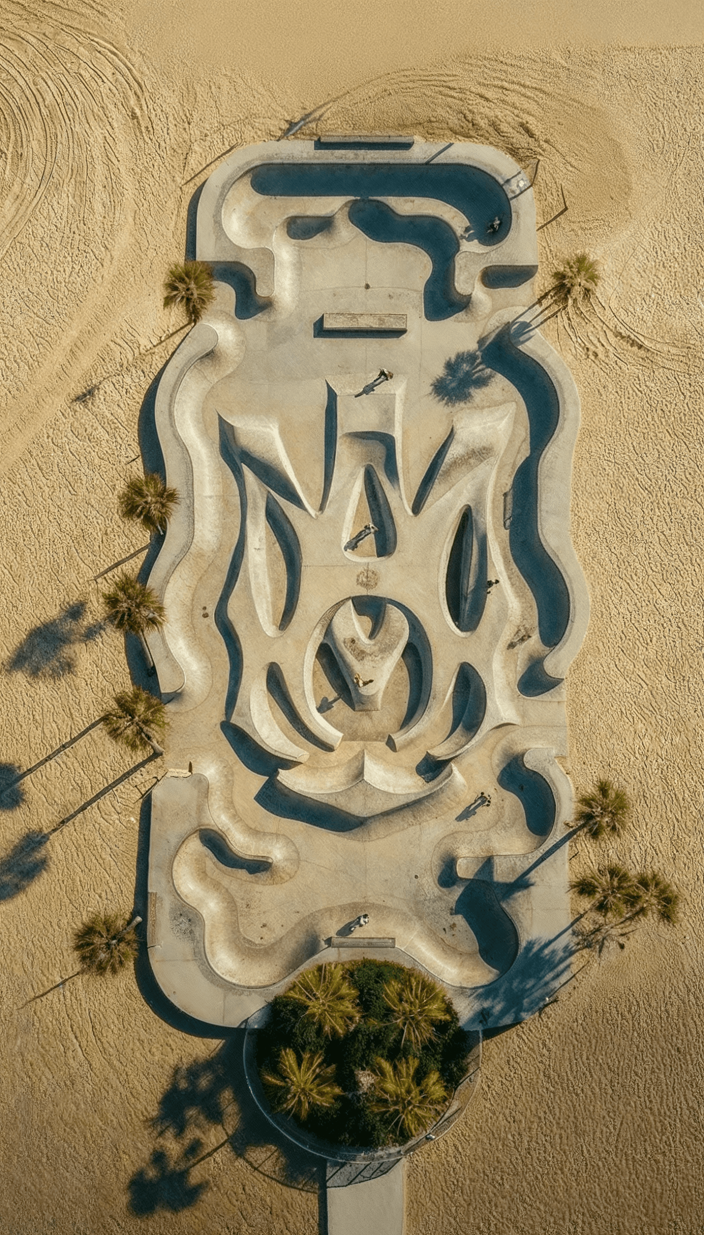 Aerial views of a beachside skatepark custom-shaped into the Amiri brand monogram