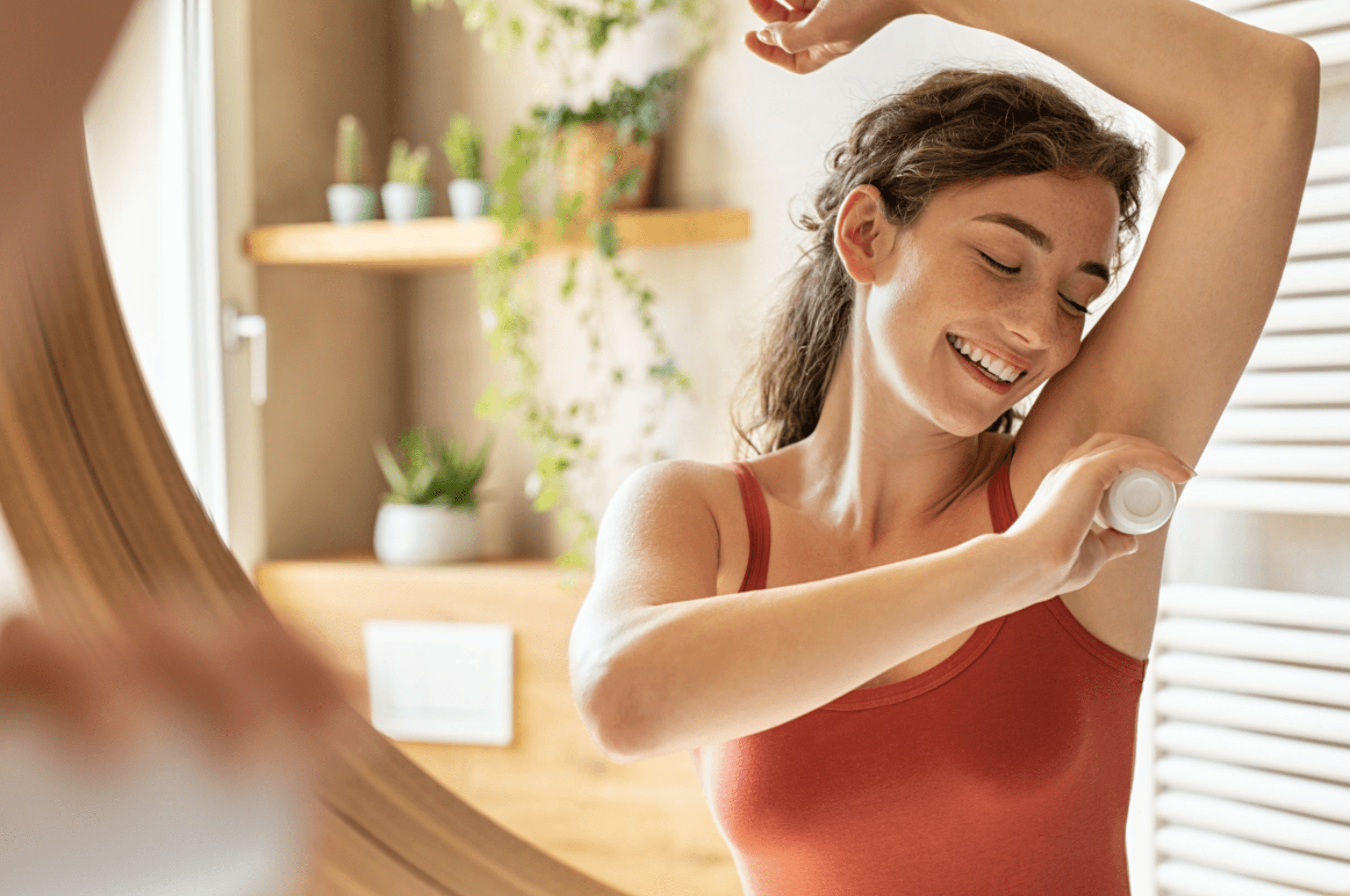 Woman putting deodorant on