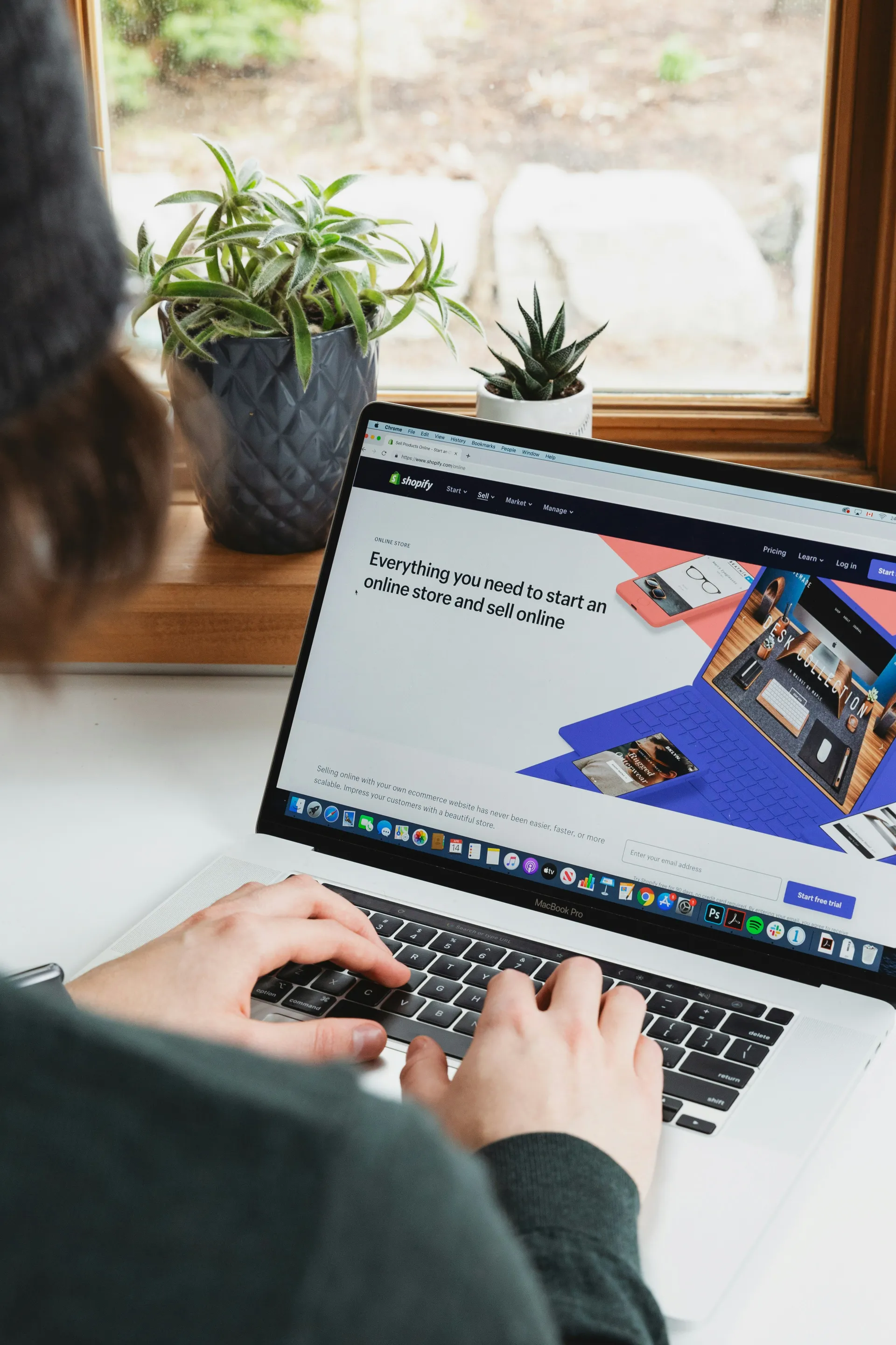 A professional web designer reviewing layout mockups on a laptop screen for a SplitScreen client project.