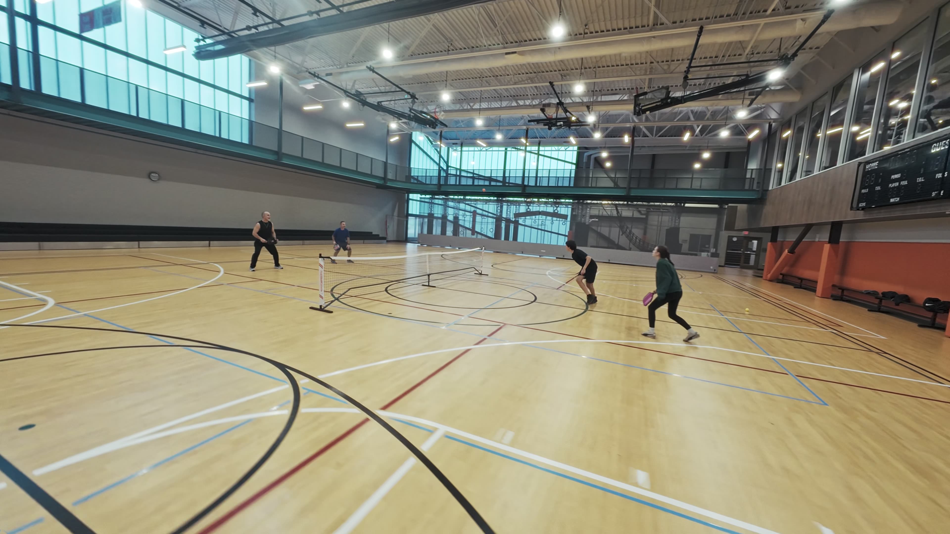 Modern bathroom featuring wooden cabinetry, a bathtub, a sleek sink, and natural light from a window.