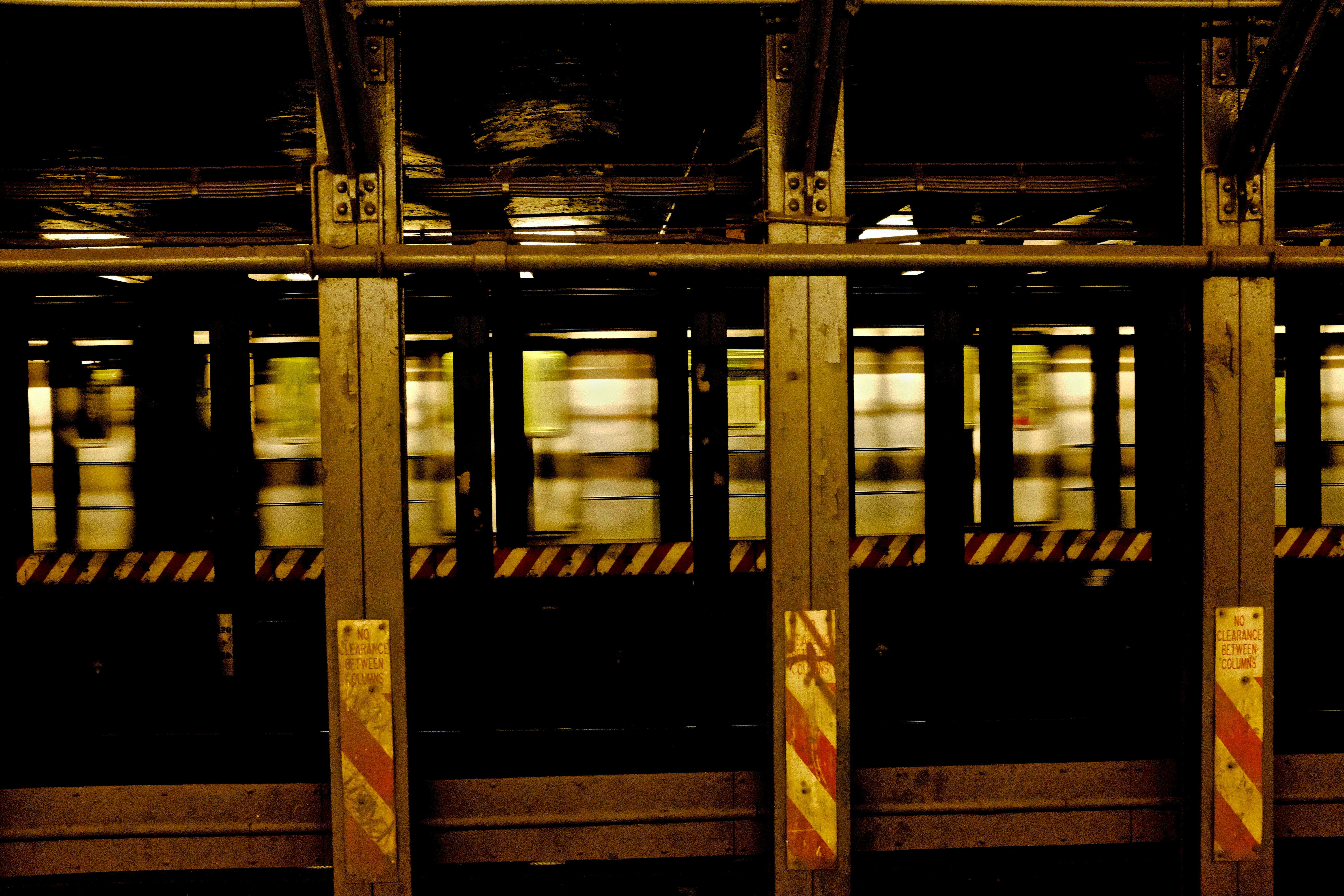 a subway train is moving through the station