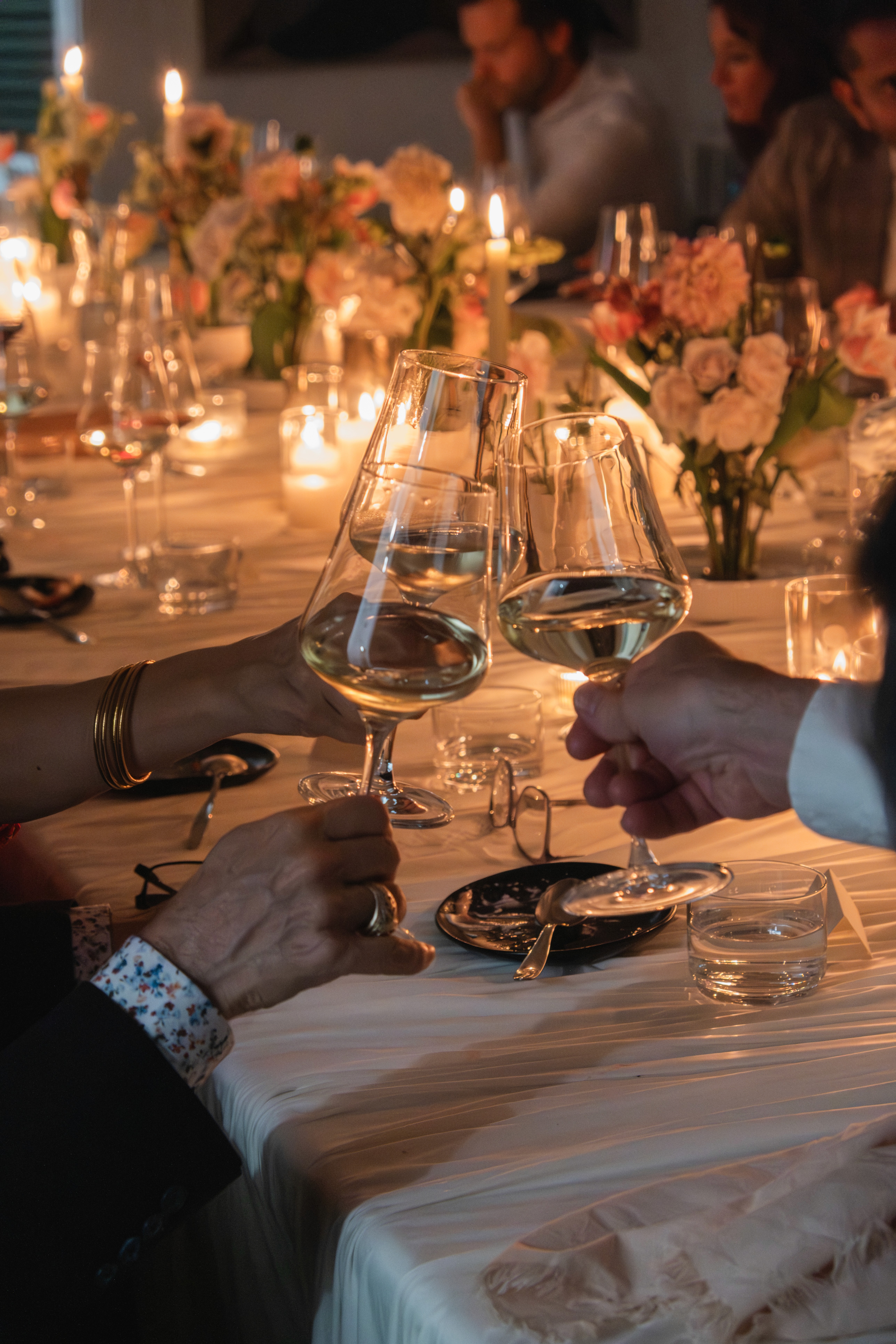 Guests raising champagne coupes at an intimate, elevated wine gathering—reflecting SNOOTI’s private wine membership and sommelier-curated experiences.