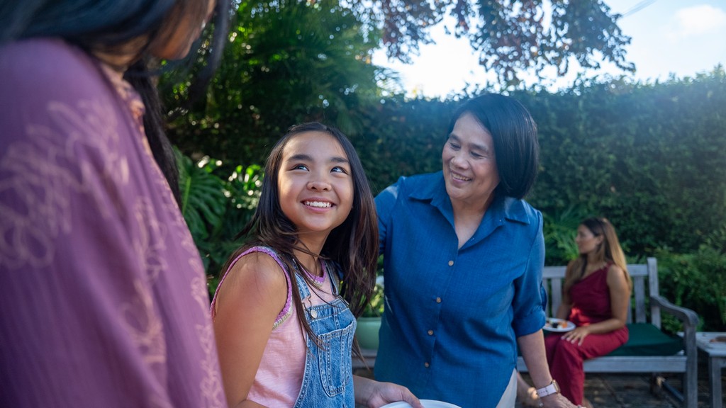 Mother and daughter smiling outdoors in Hawai‘i