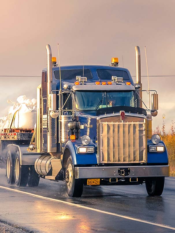 Semi Truck Driving down wet road