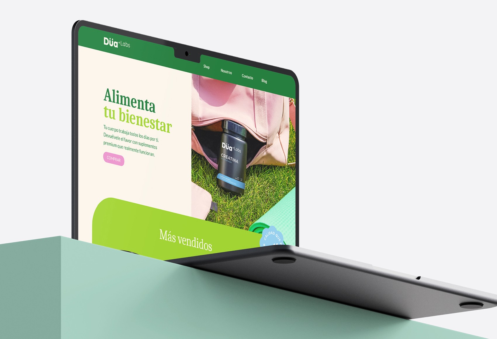 A sleek laptop displays a vibrant website with a focus on health and wellness, featuring a nutritional product and clear, modern design, set on a minimalist mint-green pedestal.
