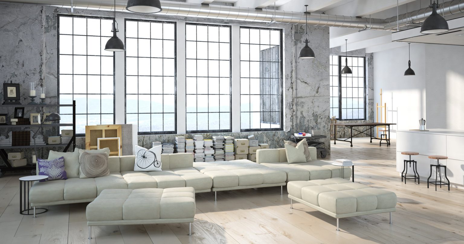 Modern indoor space with large glass doors, lush greenery, and a cozy seating area visible beyond.