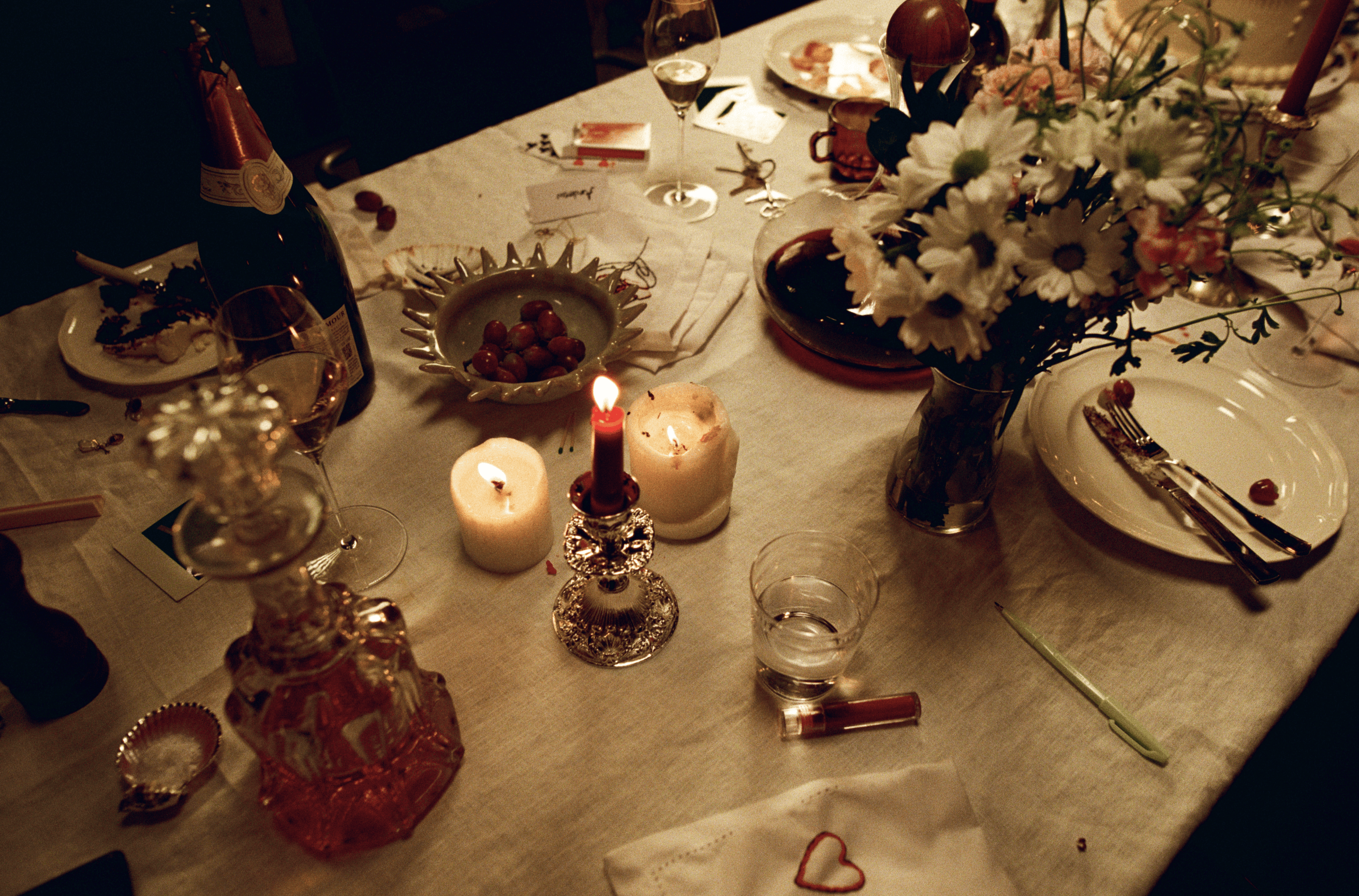 A decorative floral arrangement spills over a table draped in red fabric, creating an elegant atmosphere.