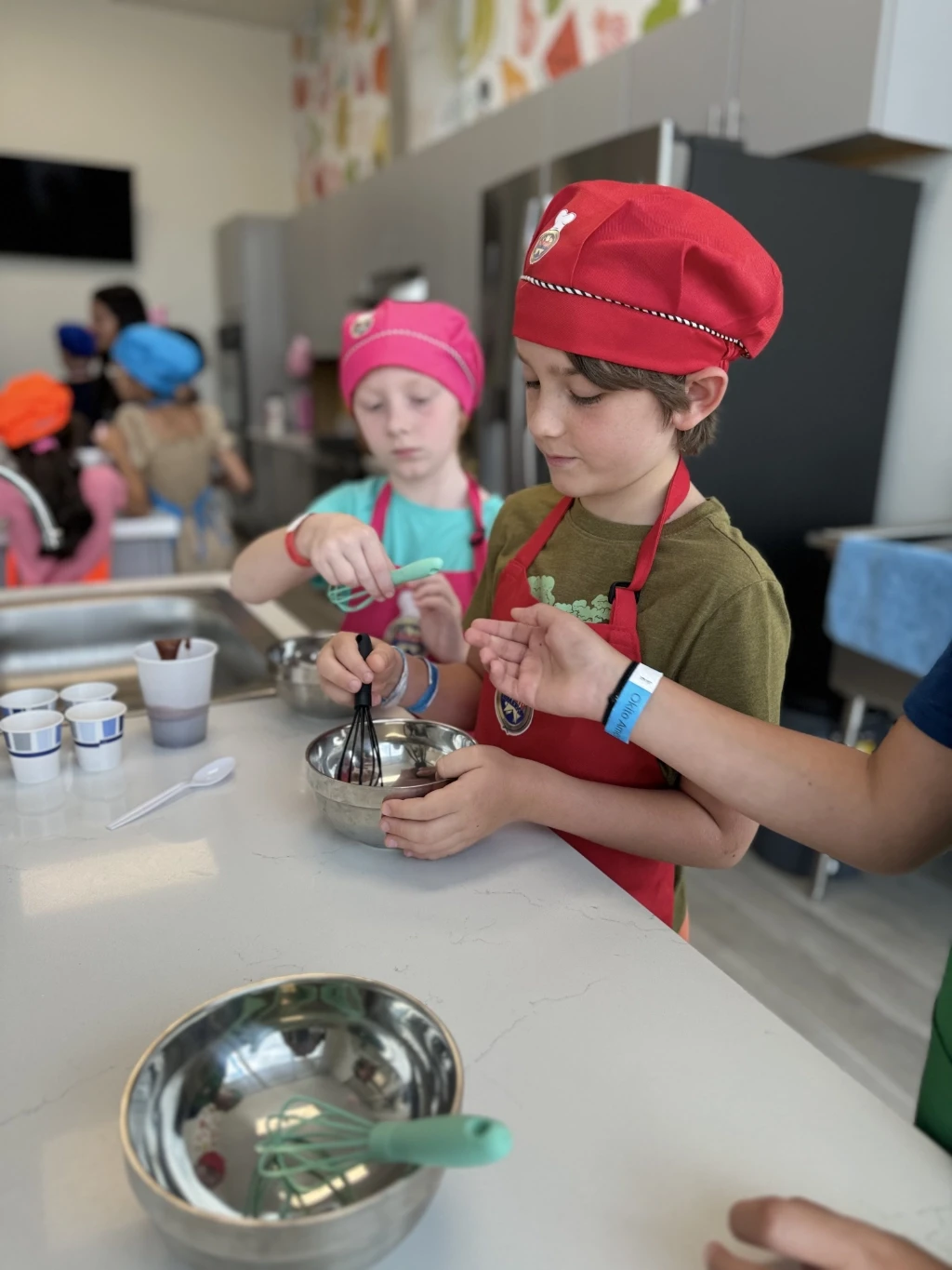 boy mixing ingrdients in ncookingn class.