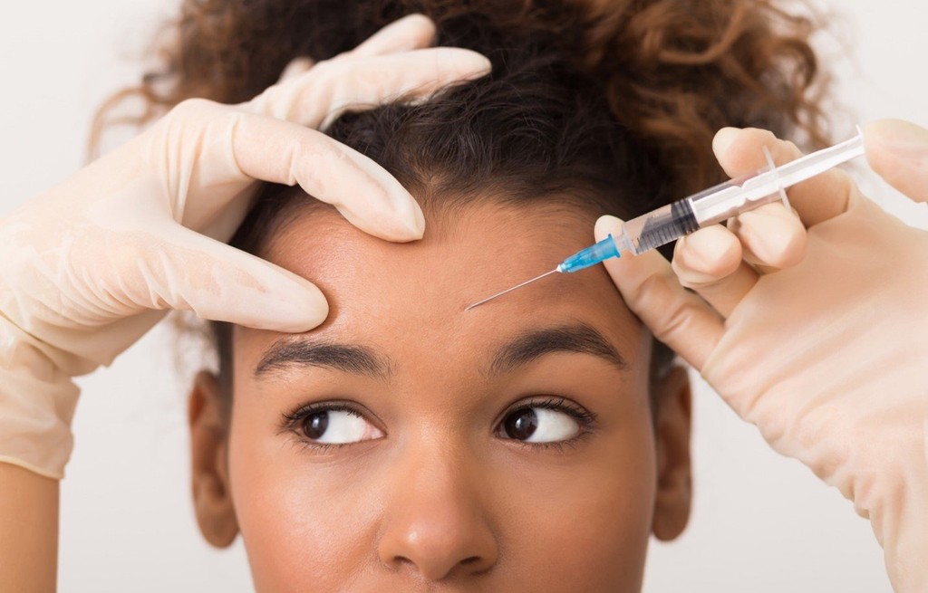 Patient receiving Botox injection in the forehead at a medical spa in Delray Beach, Florida. Aesthetic treatment for wrinkle reduction and smooth skin.