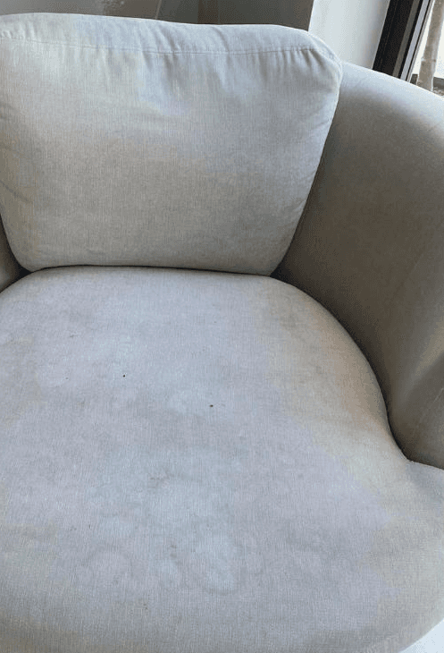 woman in white long sleeve shirt and blue denim jeans standing beside white wooden framed glass