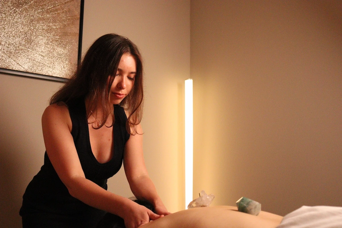 Reiki master assessing a client's neck before treatment