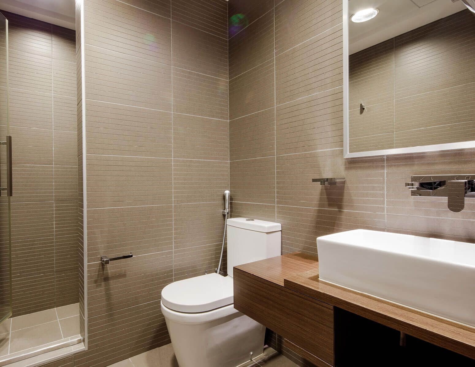 Sleek and contemporary bathroom design in a Rolex Tower residence, highlighting modern property standards.