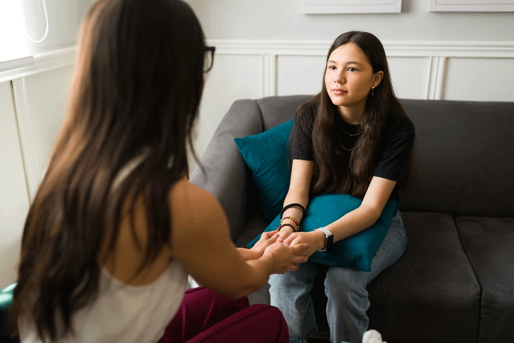 teenager speaking with therapist during counseling session