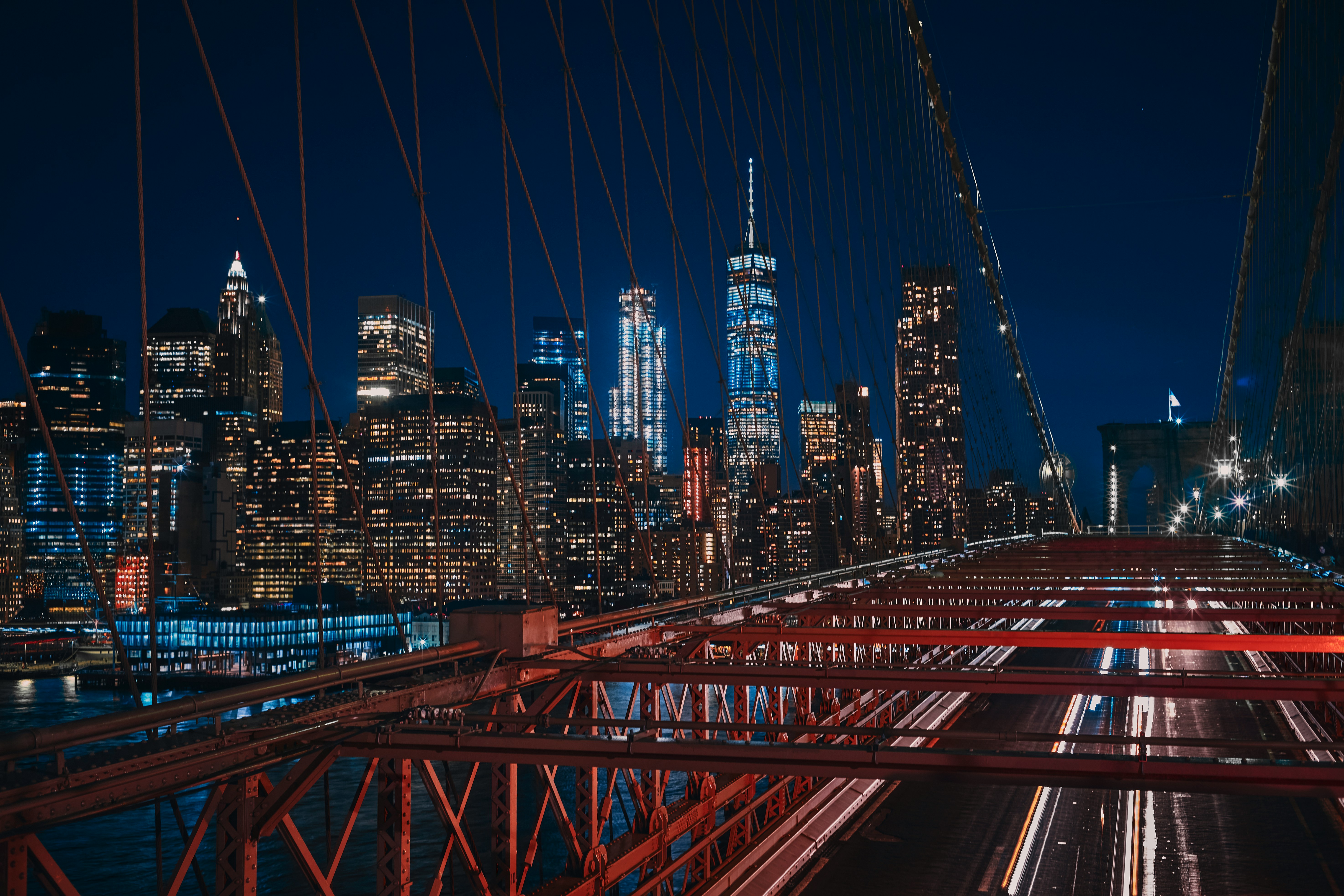 bridge near city buildings during nighttime
