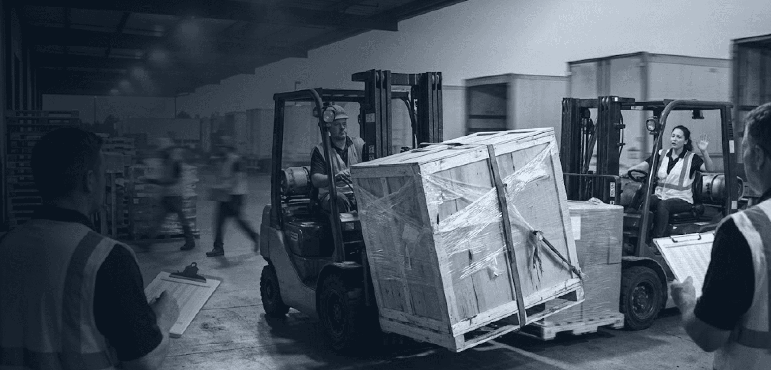 Forklifts colliding while moving crated freight, illustrating warehouse safety and handling risks