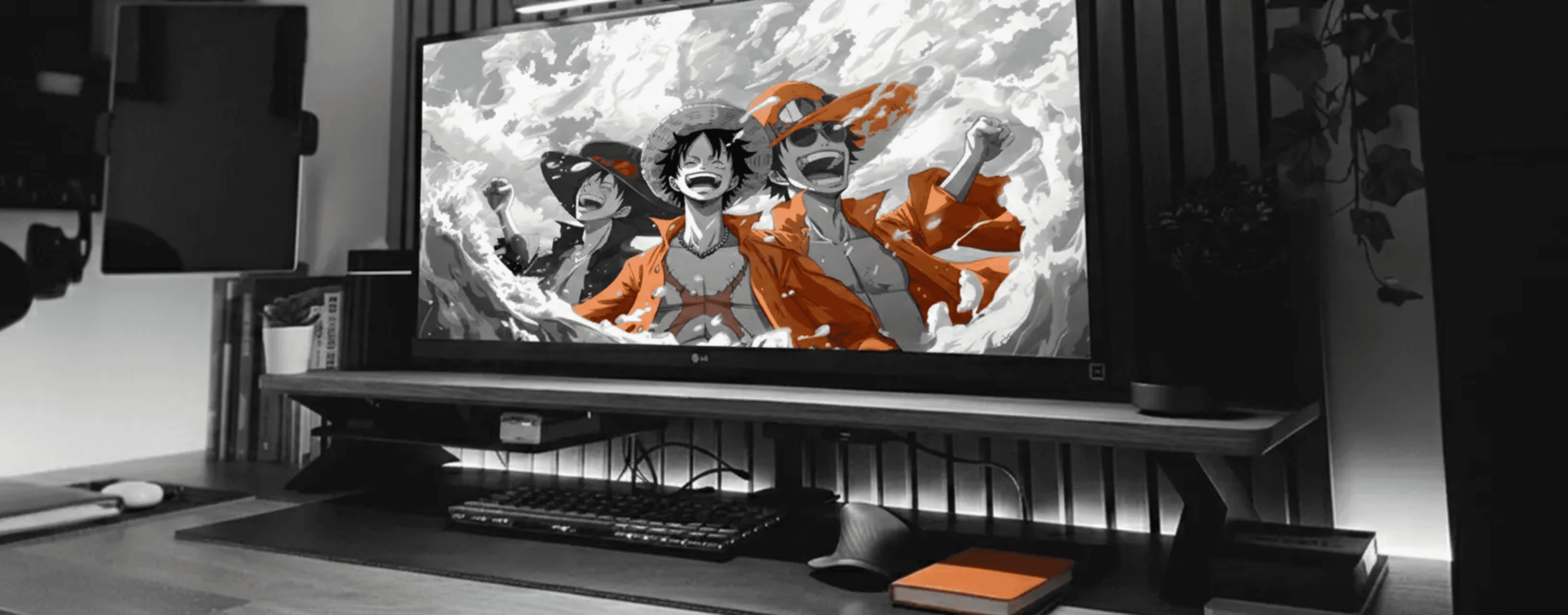 Modern minimalist desk setup with a computer monitor, microphone arm, camera, and indoor plants, featuring a pegboard with accessories on the wall and a Bauhaus-style poster leaning against the wall.