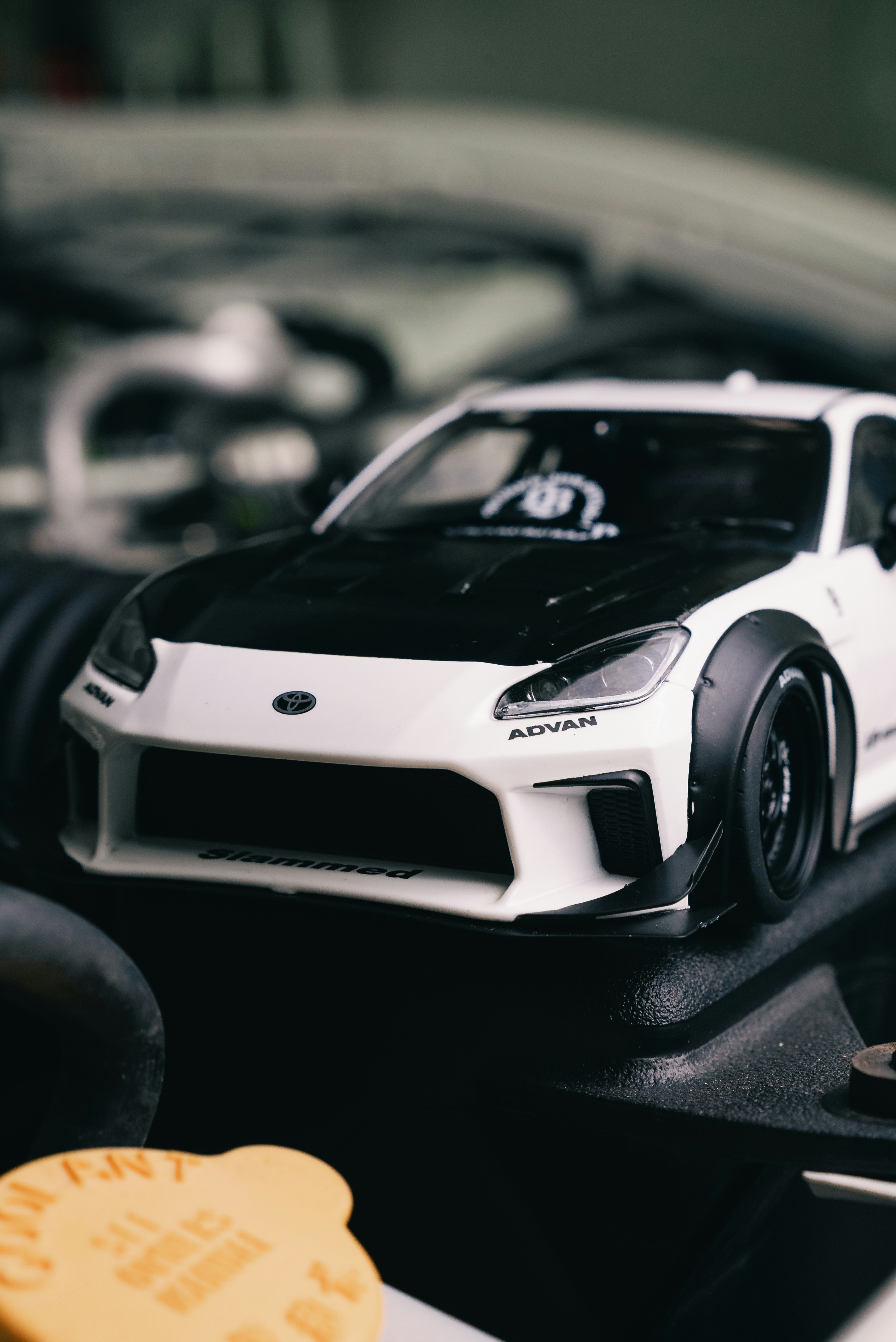 White and black model car with wide body kit