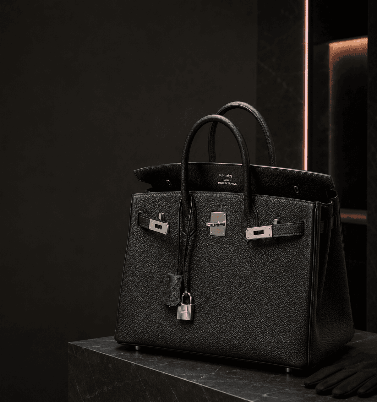 Hermès Birkin handbag with visible maker branding in a dark luxury editorial setting