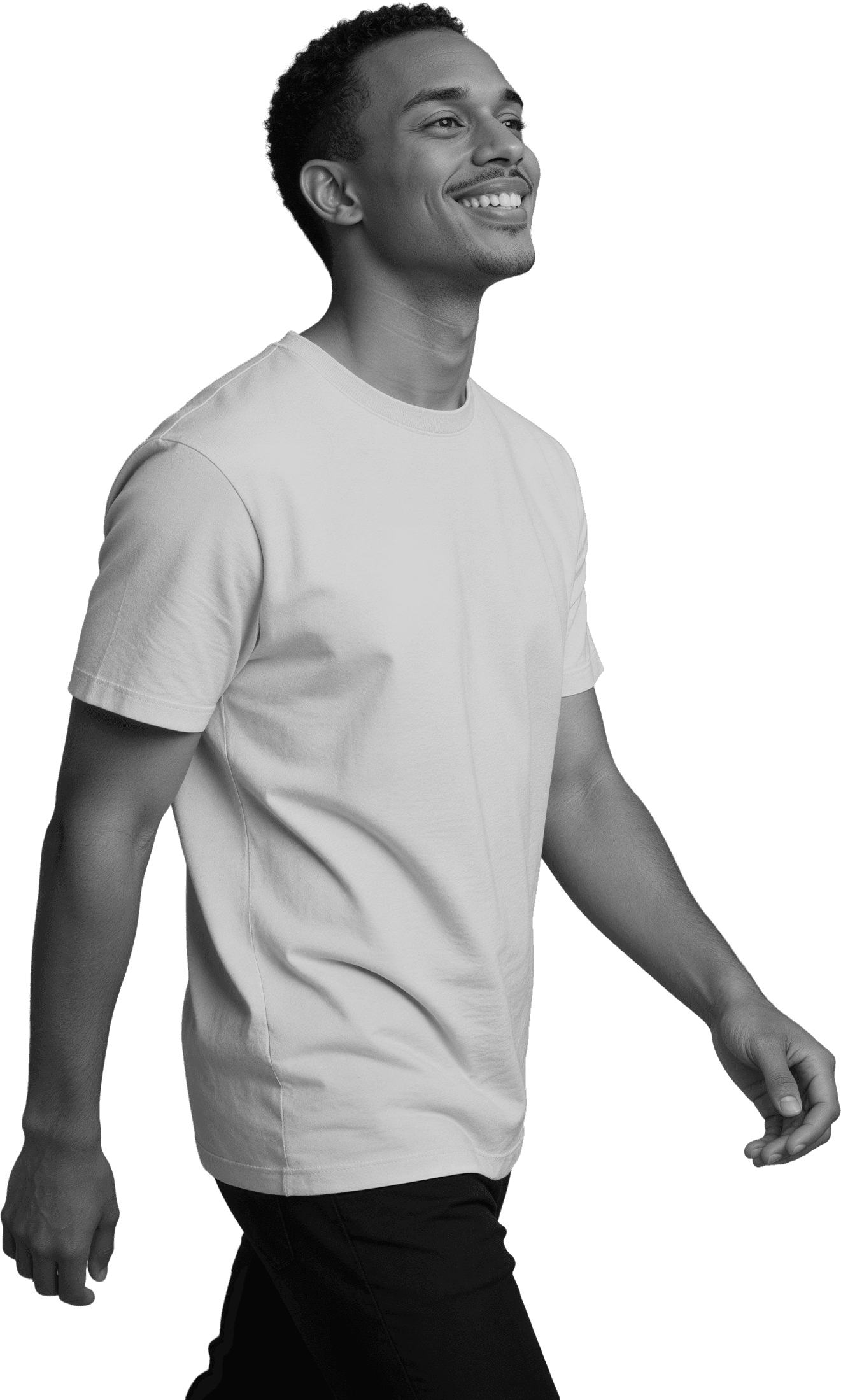 Side profile of a joyful man walking and looking up with a big smile, captured in high-contrast monochrome